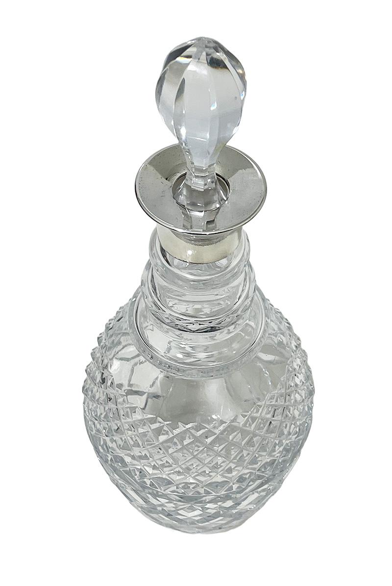 Crystal Decanter with silver neck mount by Vander, London 1974

An English crystal glass decanter/carafe with silver neck mount and a glass stopper. The silver was made by C.J. Vander, London. Marked with the
Maker's mark, Lion for the English