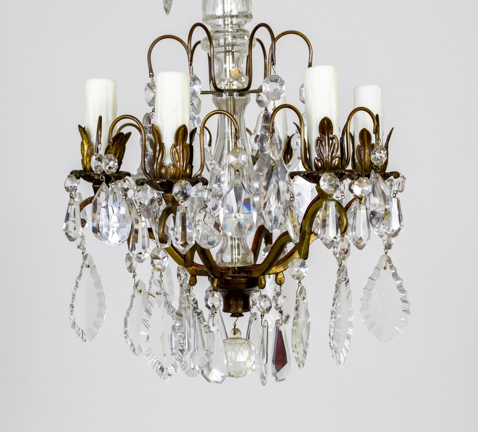 A compact, 6-light chandelier with high quality, faceted pendelogue and almond crystals and brass, acanthus leaf candle holders. Made in Austria, 1930s. 13.5