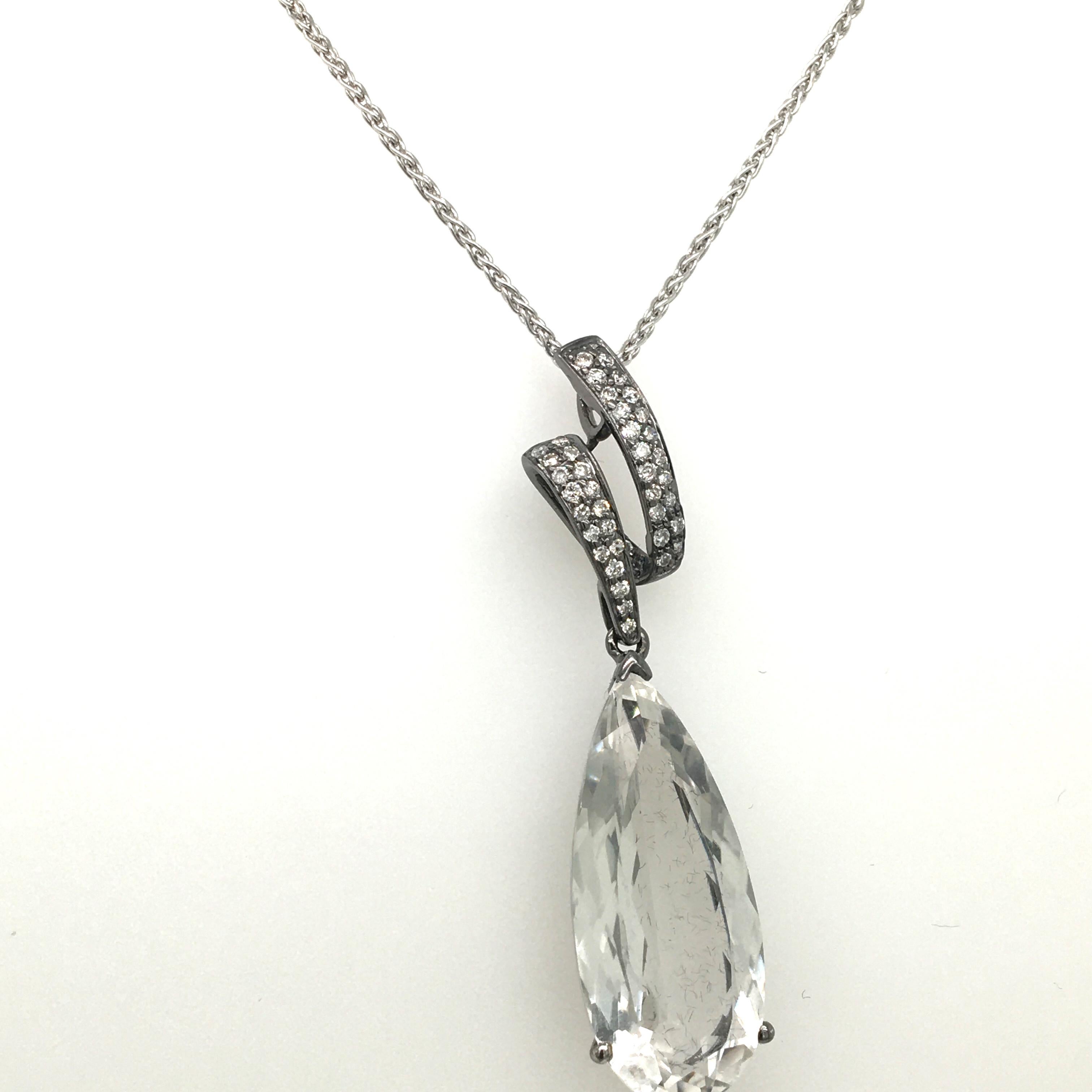 18 KT white gold pendent set with pave' diamonds 0.23 carats and a long faceted rock Crystal drop pear shape stone, chain 40 CM, total pendent length 49 CM made in Italy comes in a Box
