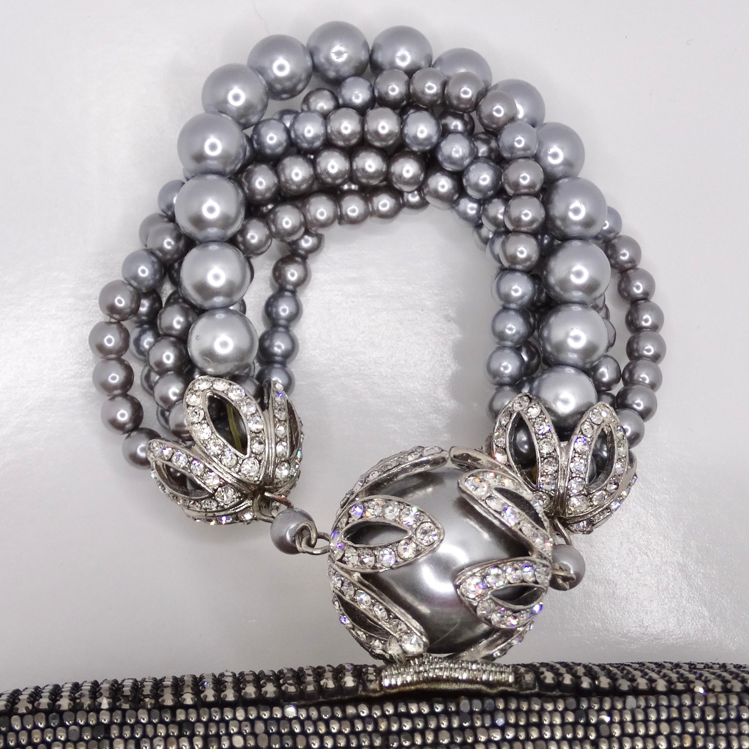 Voici la pochette ornée de cristaux et de fausses perles, un accessoire glamour et élégant qui respire la sophistication intemporelle. Cette pochette classique arrondie est dotée d'une enveloppe rigide recouverte d'une pléthore d'embellissements en