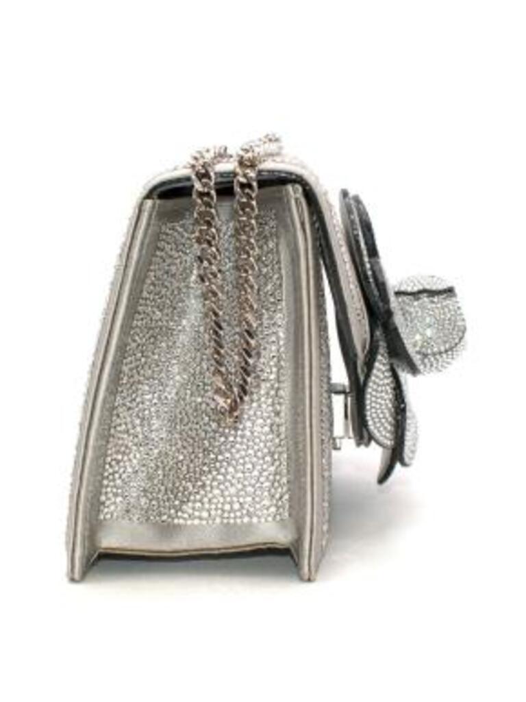 Oscar de la Renta crystal embellished flower box bag
 
 - Structured, crystal-encrusted box bag with a large 3-D floral motif on the front flap
 - Detachable chain shoulder strap 
 - Opens to silver leather lined interior
 
 Material: 
 
 Satin 
