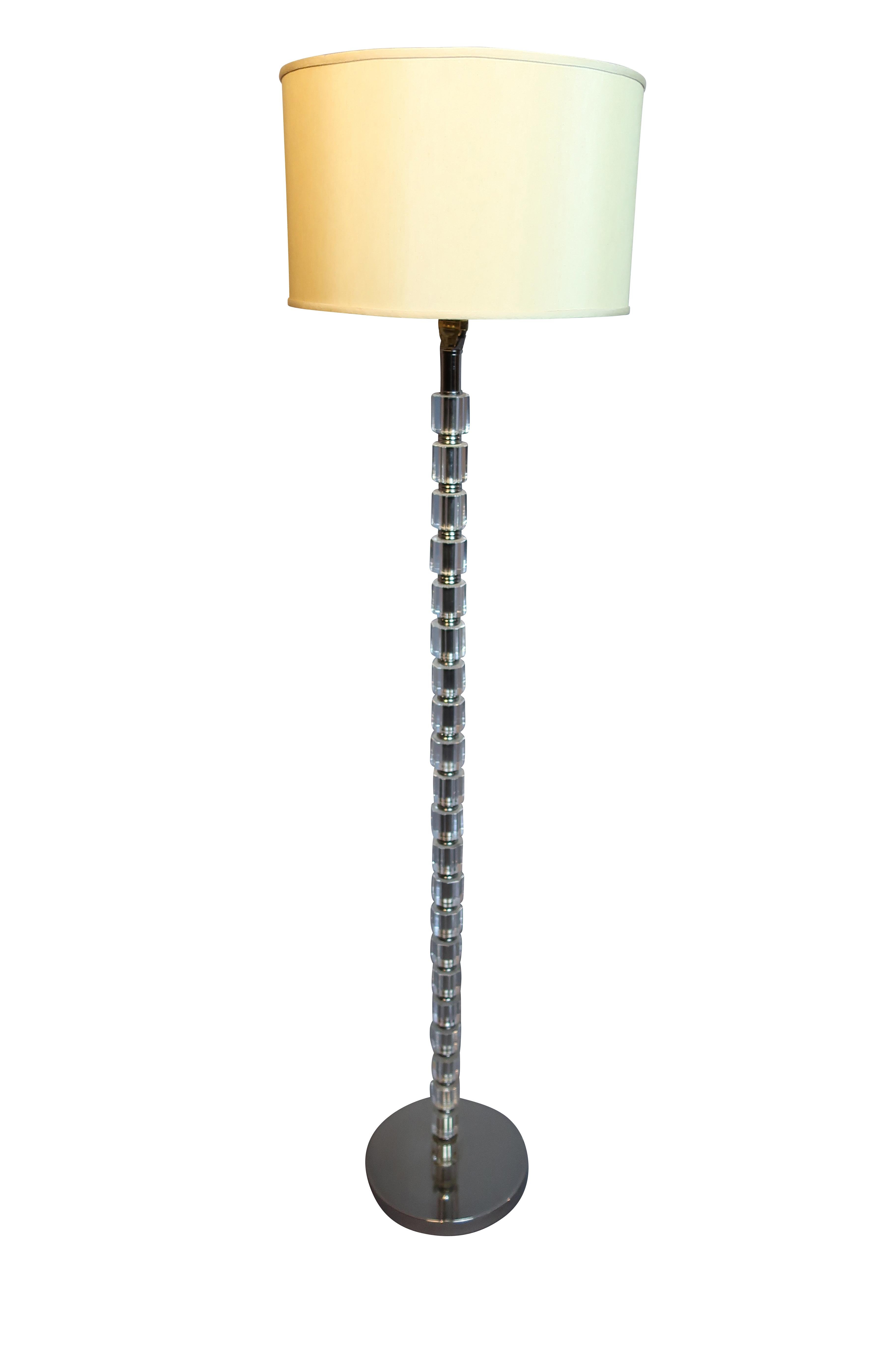 Crystal floor lamp with faceted glass pole and chrome base, contemporary styling with an off white linen drum shade. Measures: 62 inches high, with shade, the base is 10 inches in diameter, shade measures 15.25.