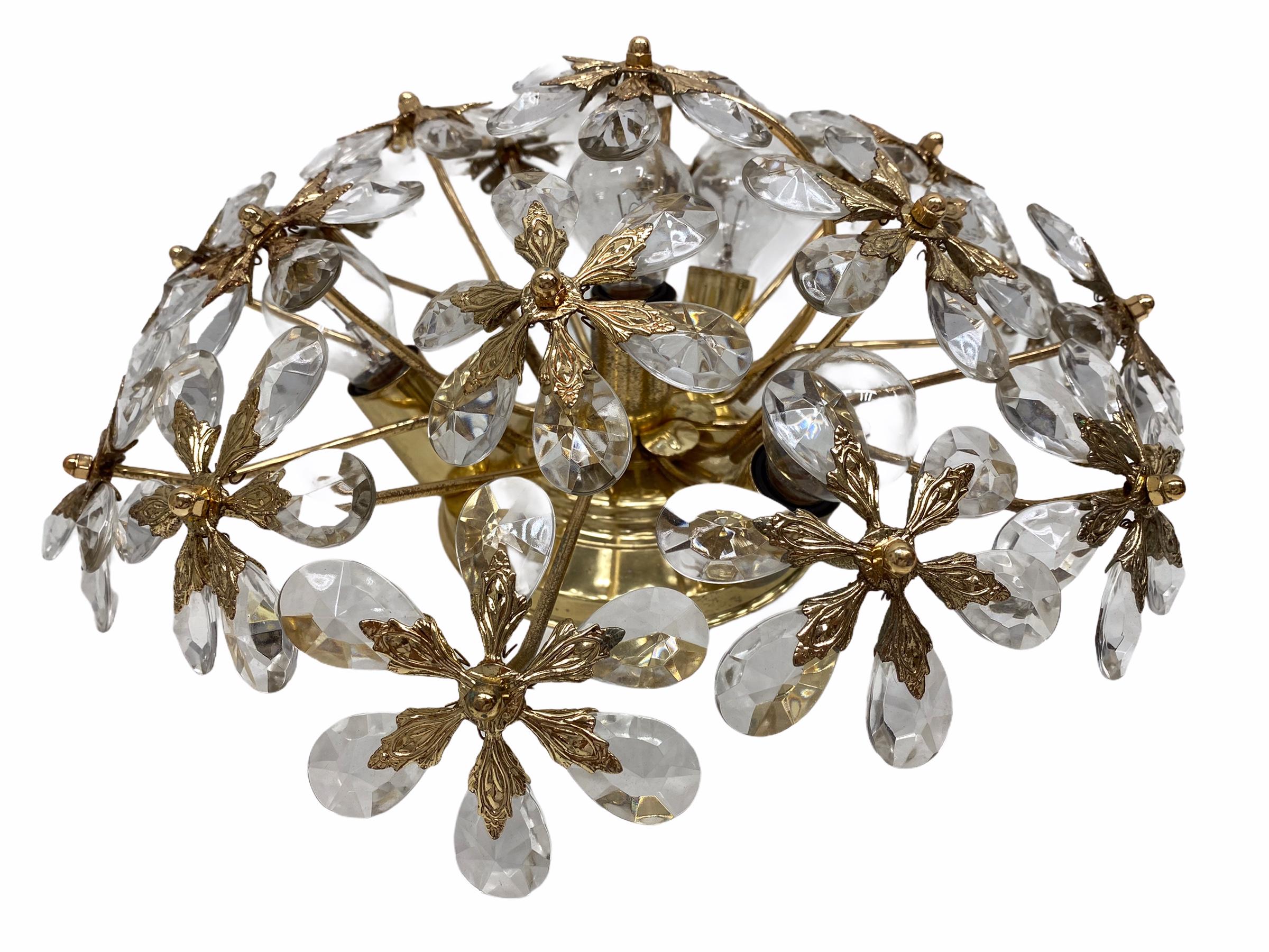 A large and beautiful flush mount chandelier by Palwa, Germany. It is made of a gilded brass frame and crystal glass. It takes four European E14 / 110 Volt candelabra bulbs with max. 40 Watt per bulb. Frame with oxidized spots, but this is old-age.