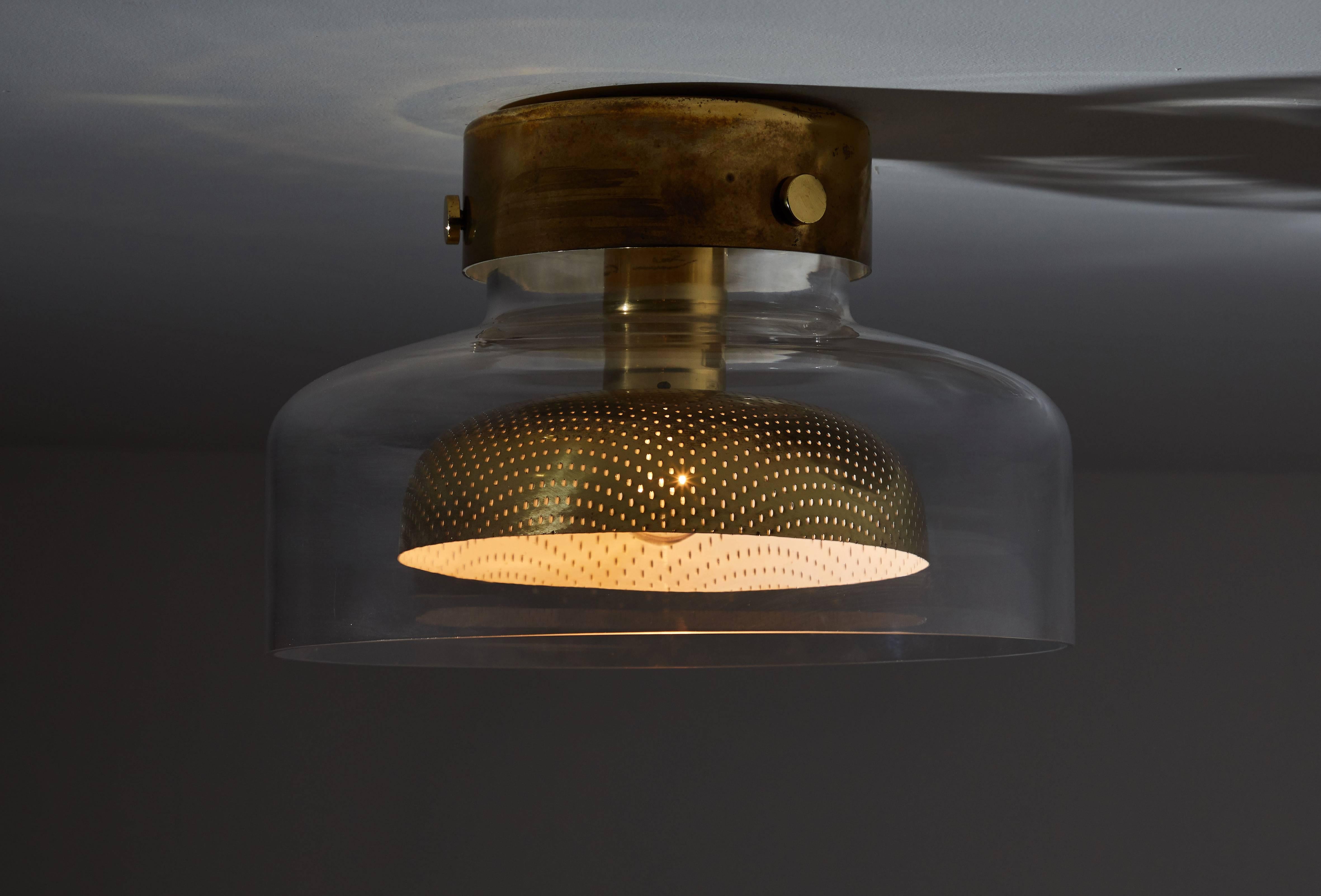 'Crystal' flush mount ceiling lamp by Anders Pehrson for Atelje Lyktan. Designed and manufactured in Sweden circa 1970s. Glass and perforated brass. Rewired for US junction boxes. Takes one E2 7100 w maximum bulb.