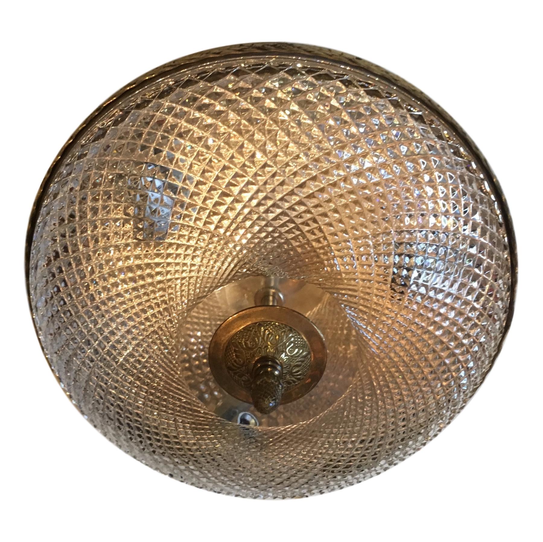 A circa 1930s French crystal flush-mounted ceiling fixture with bronze fittings and interior lights.

Measurements:
Diameter 12?
Drop 4?
