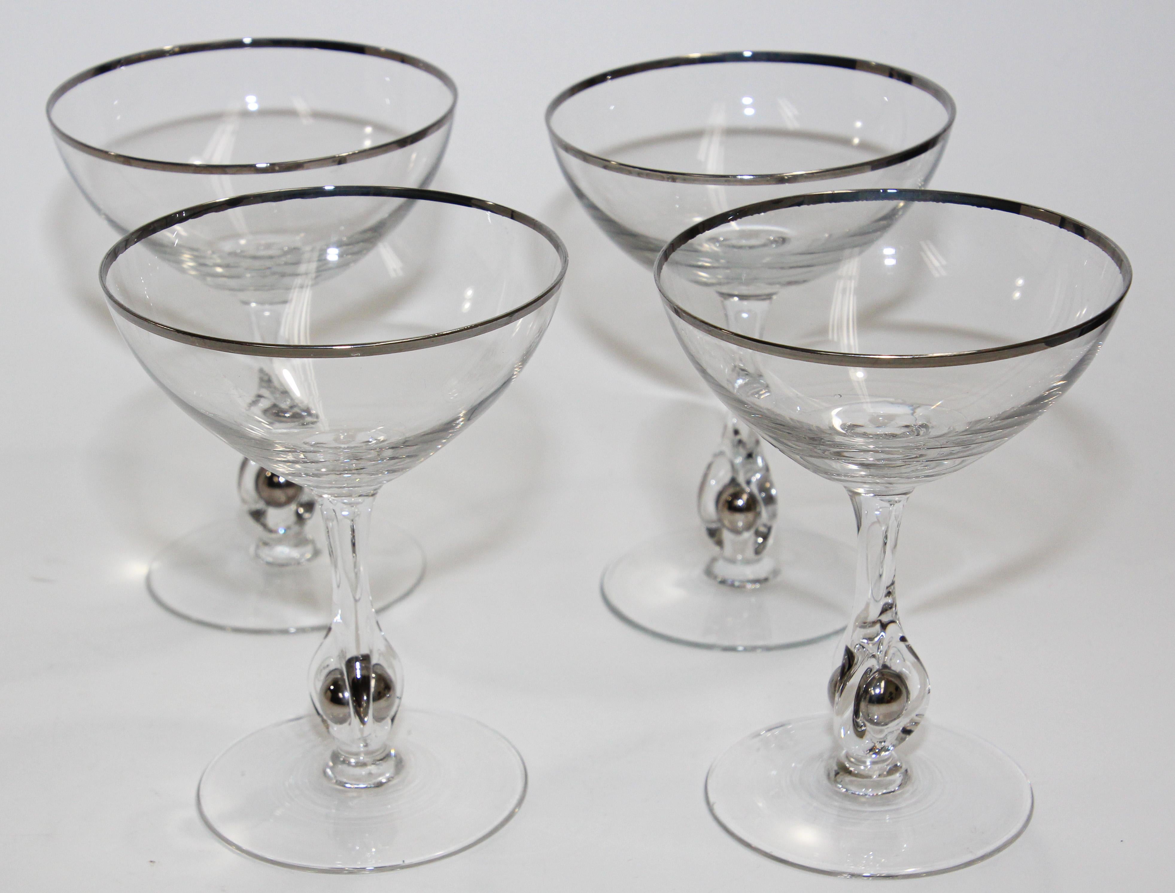 Vintage footed drinking glasses crystal goblets, glassware.
Elegant vintage midcentury crystal champagne footed glasses, silver rimmed.
This exquisite set of four crystal stemware champagne coupes, sherbe has a silver rim. 
The details on this