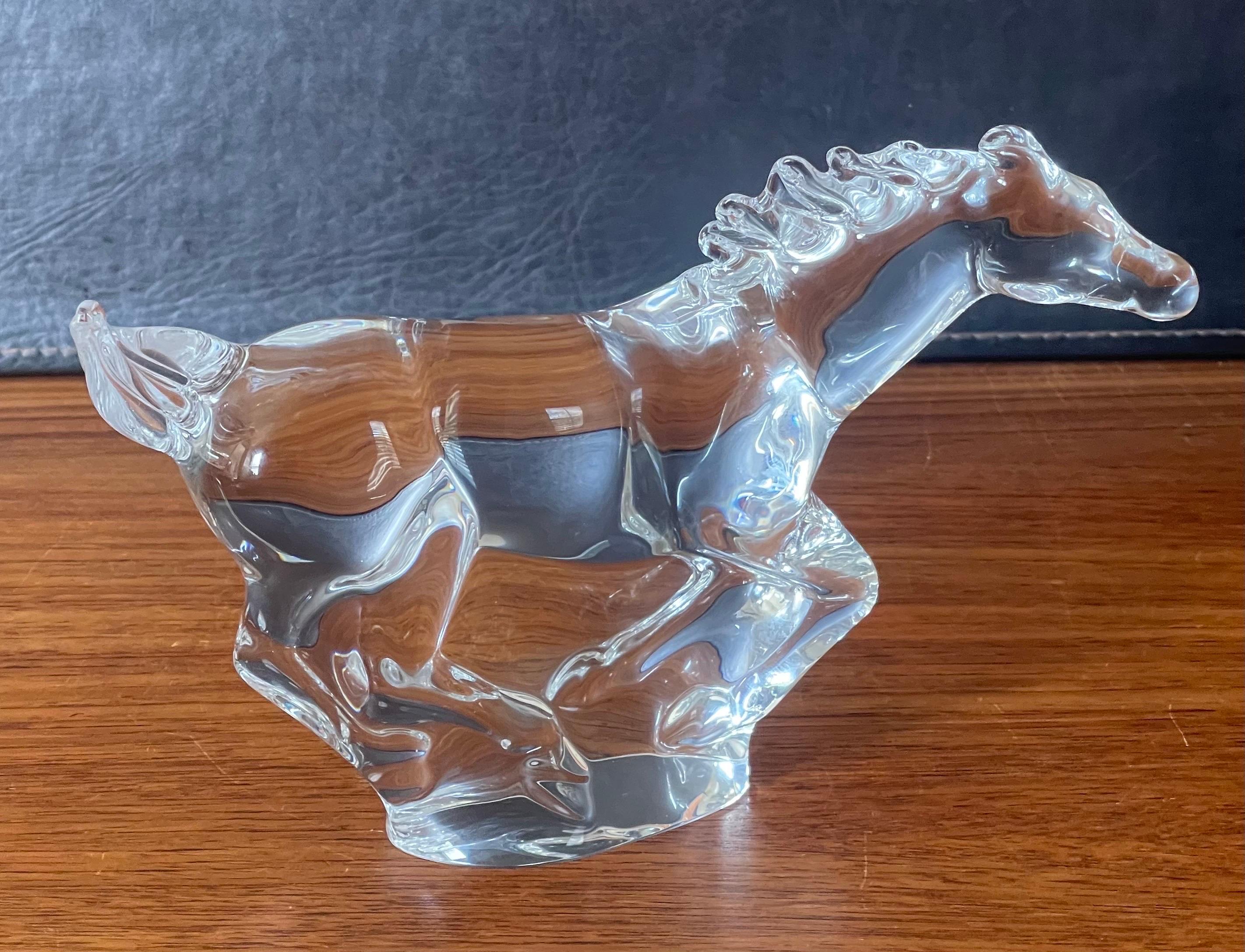 A rare crystal galloping horse / mustang sculpture by Steuben Glassworks, circa 1990s. The sculpture is in very good condition with no chips or cracks and measure 9.25