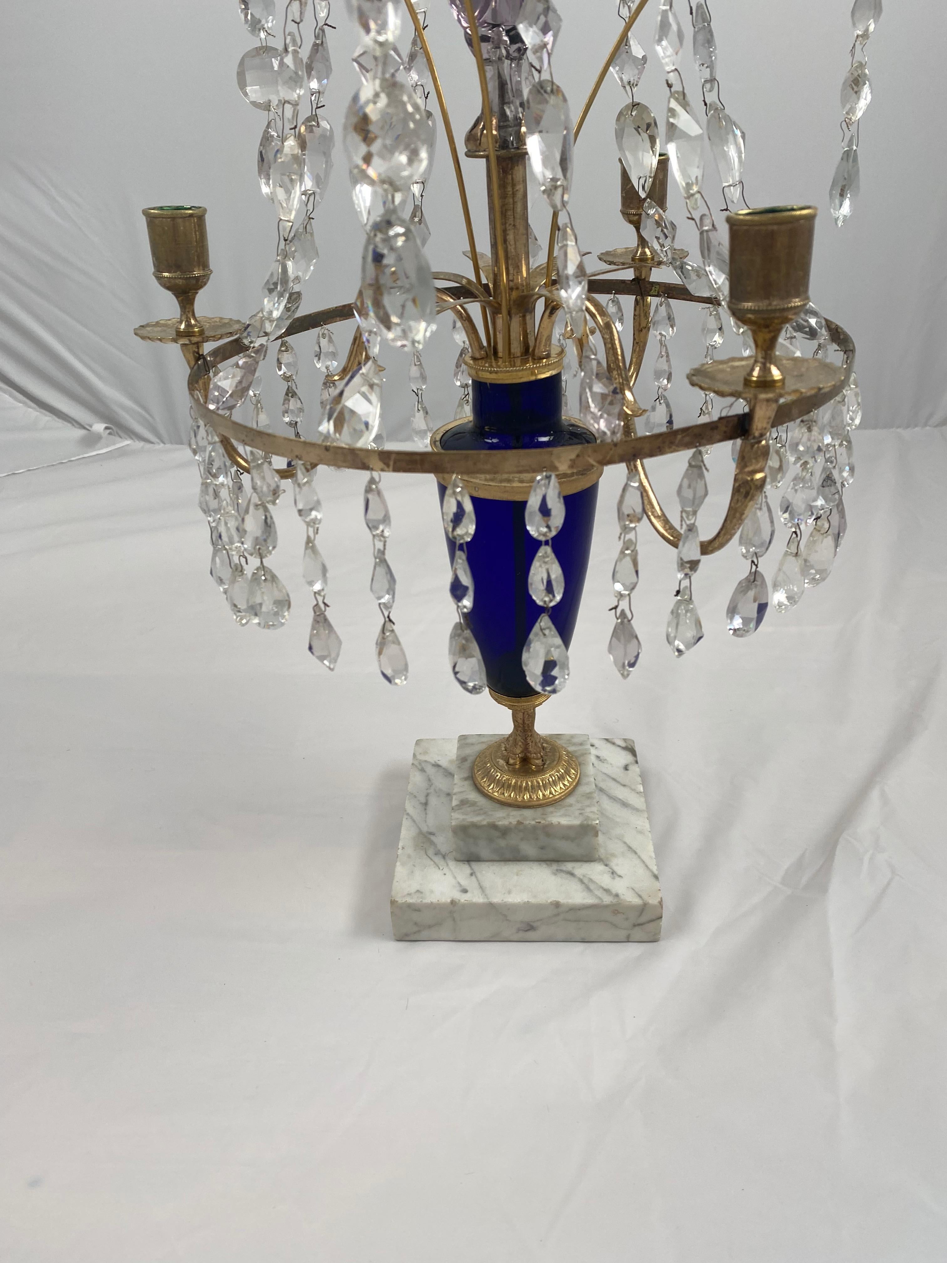 A Swedish crystal girandole made, circa 1790. A blown Cobol blue glass urn holds three gilt bronze arms and a cut crystal spear. The base is made of Carrara marble. Great condition.