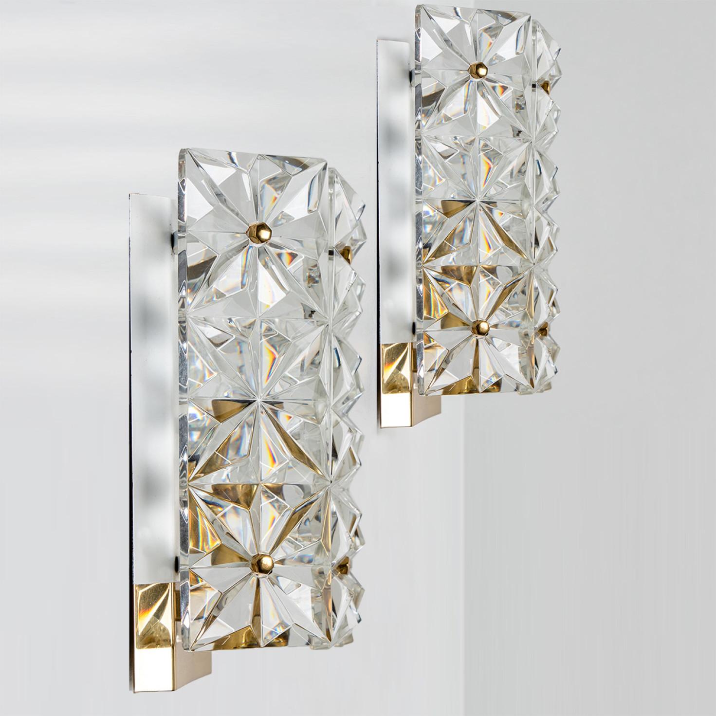 Luxurious gold-plated wall lights with thick crystal glass by the famed maker, Kinkeldey from Germany, Europe. Made in the 1970s.
Very elegant light fixtures, comfortable with all decor periods.
Star shaped crystal glass. Because of this special