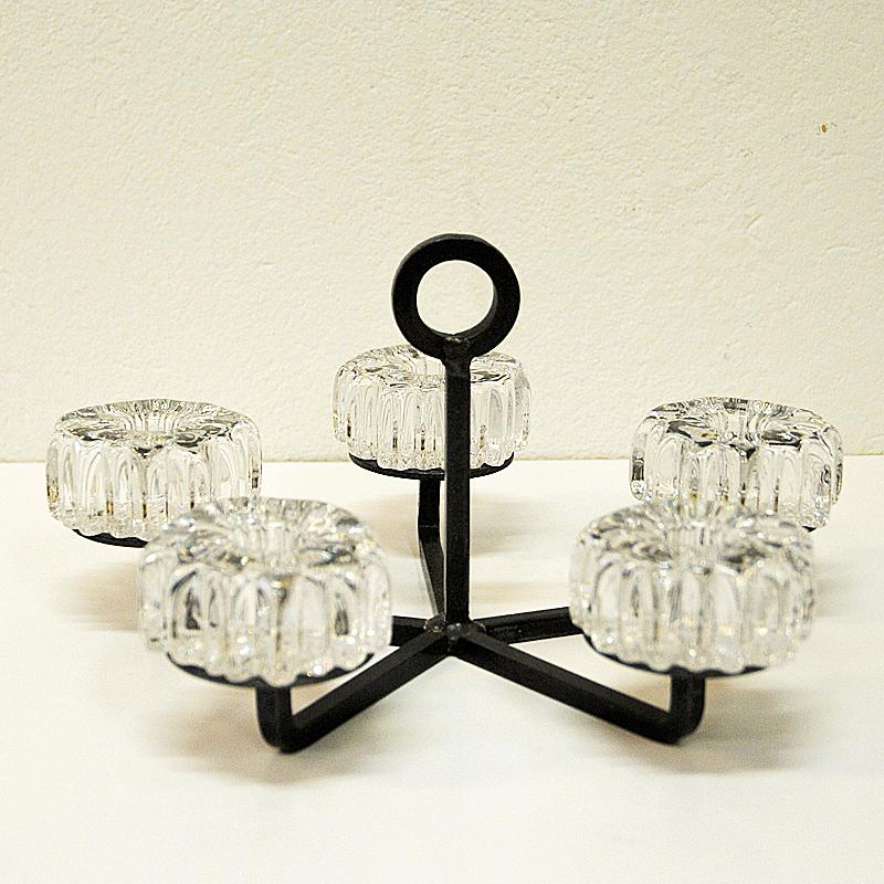 A lovely crystal glass and cast iron candleholder by Norwegian designer Willy Johansson for Hadeland Glassverk in Norway 1970s. The candleholders are made of crystal glass and named Nautilus and each have a hole for a candle light in the middle.