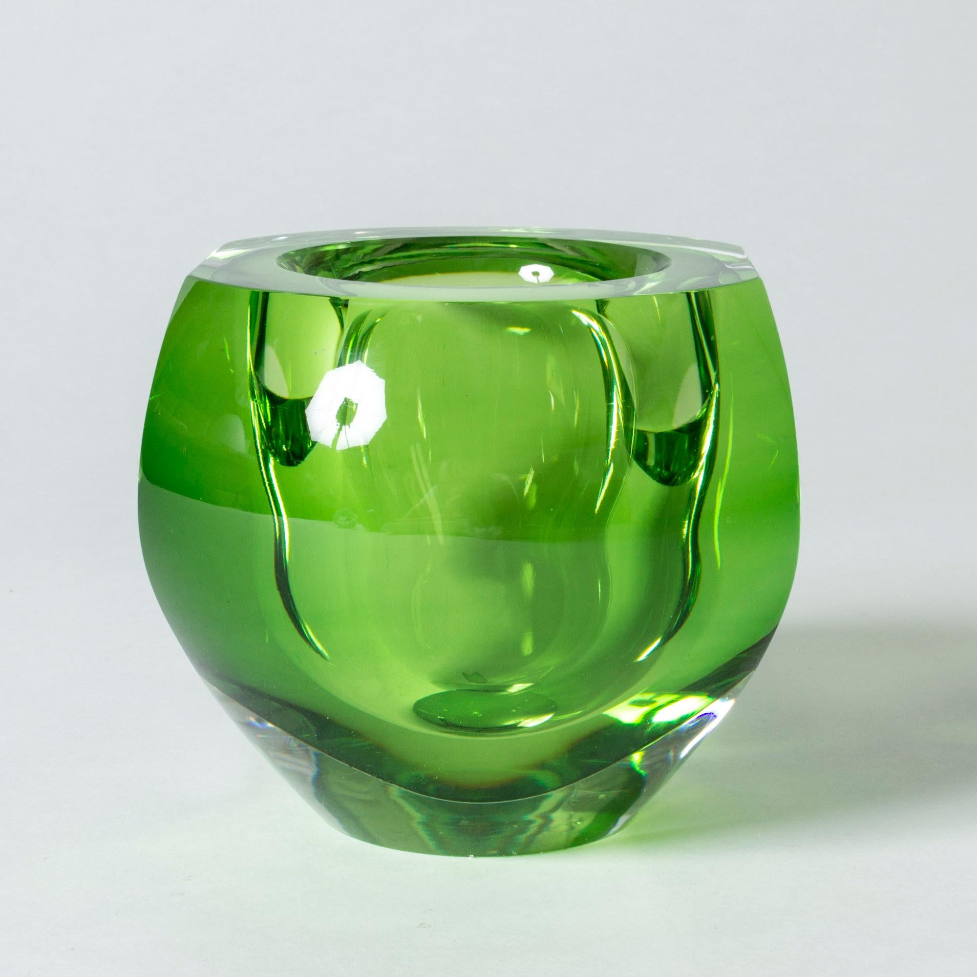 Crystal glass bowl by Mona Morales-Schildt, in heavy quality and a striking, poisonous green color. Dramatic design with a play of light in the thick glass.