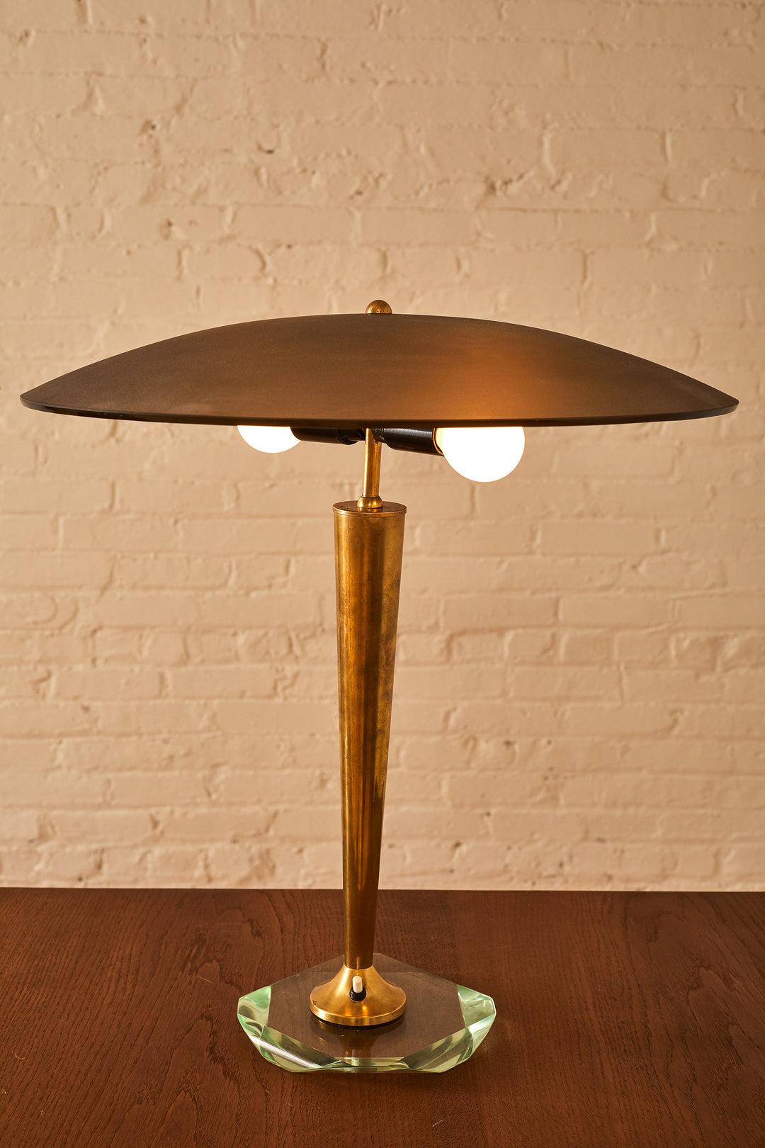 An elegant and rare table lamp attributed to Pietro Chiesa for Fontana Arte. The lamp features a crystal glass base, a tapered brass stem and a dark pink/grey smoked glass hat that can adjusted side to side. There is a light switch at the base that
