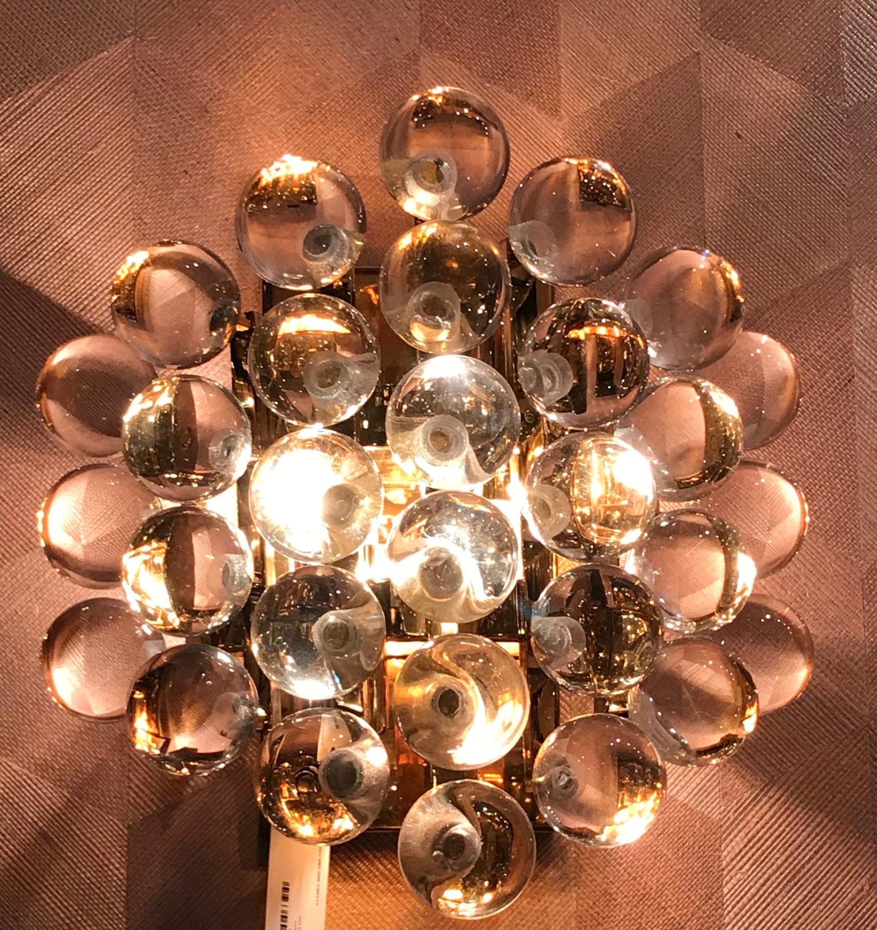 Contemporary Dutch cluster of mini crystal bubbles form a decorative pair of sconces.
They are set on a brass back plate.
When lit they pick appear to be a beautiful gold.
When unlit they are clear.
Two candelabra bulbs in each sconce, 40 watt