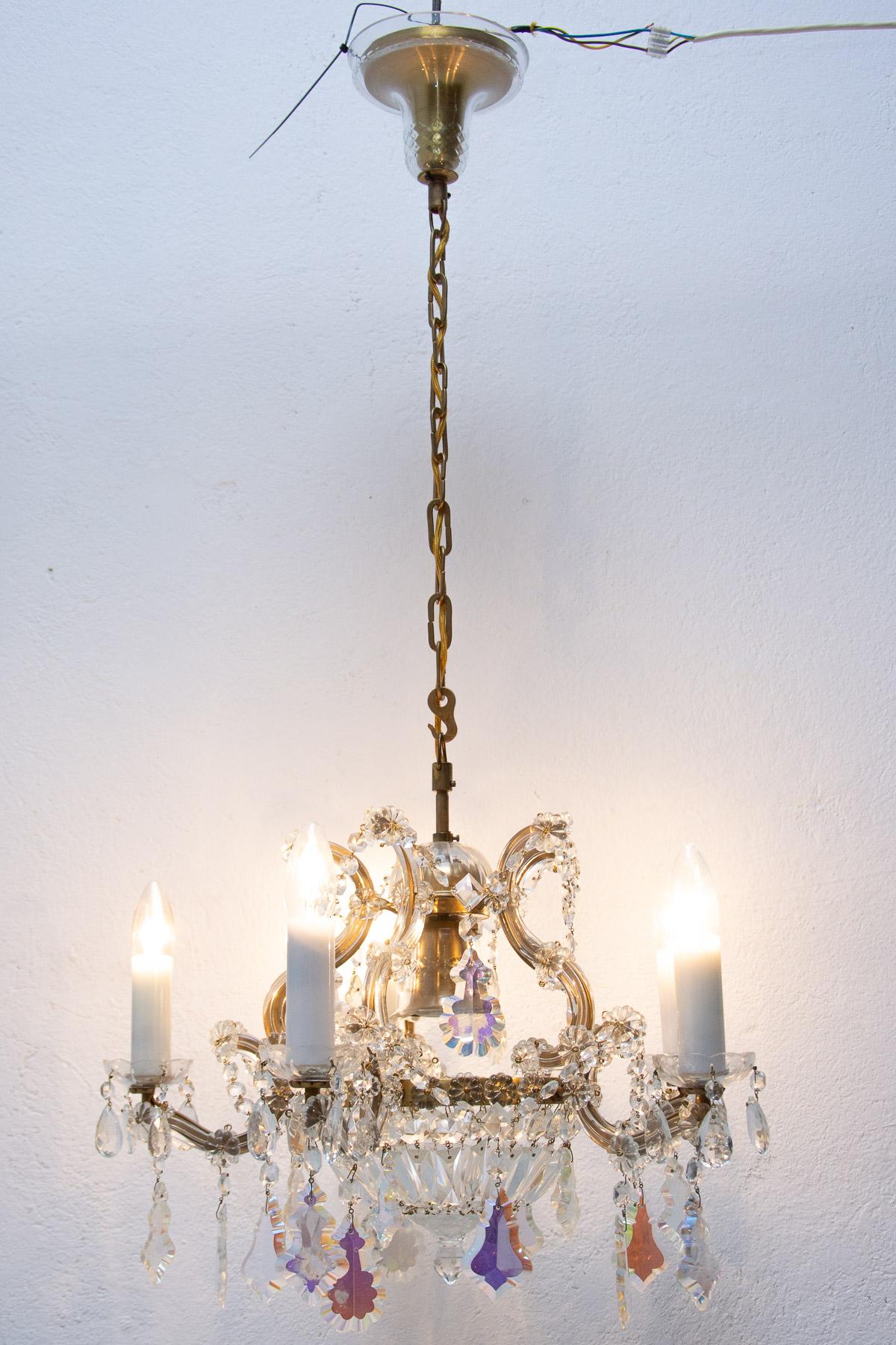 This beautiful crystal glass chandelier was made in the 1930s in the former Czechoslovakia. It has a new wiring. An excellent quality piece, it has a cut glass beads and pendants hanging from the brass centre. In very good Vintage
