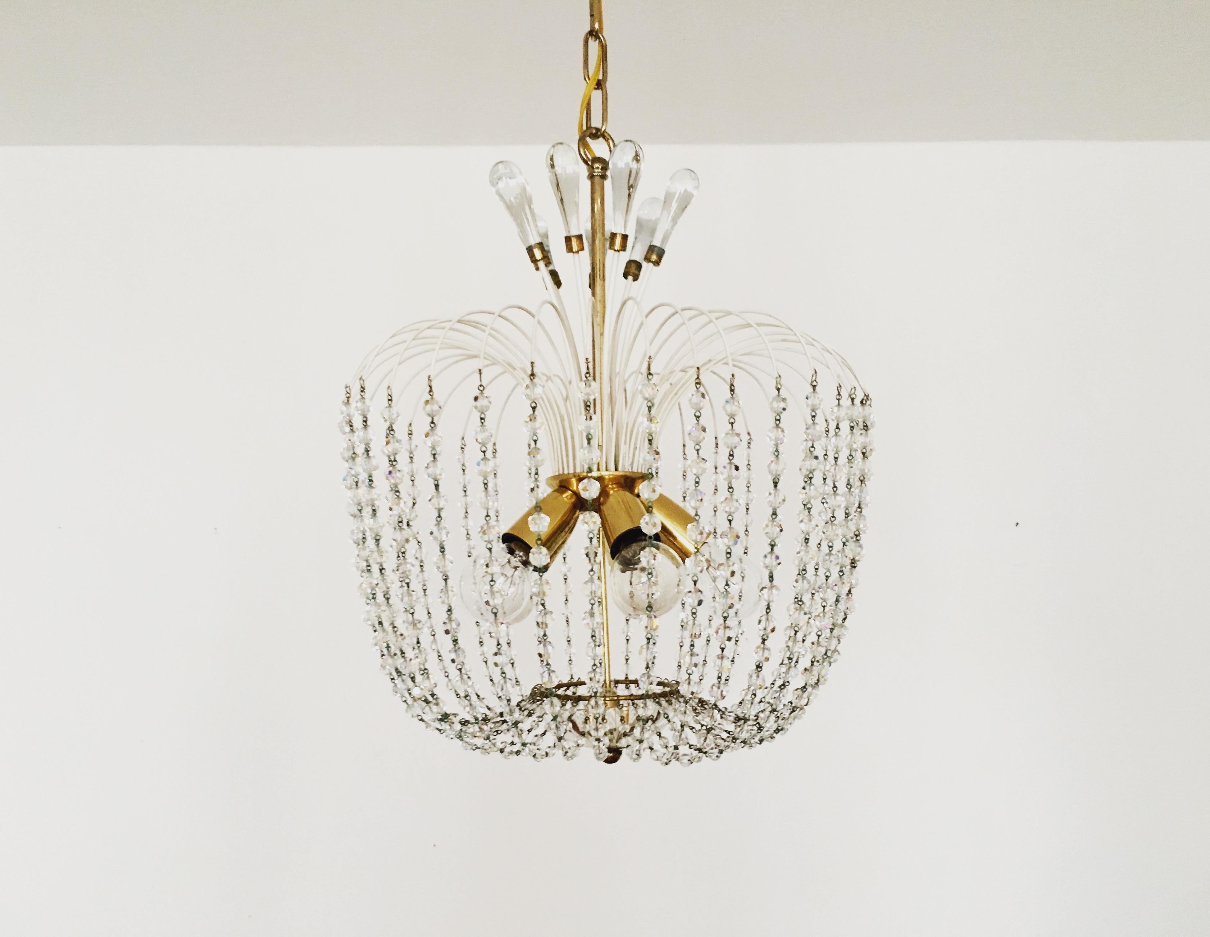 Extremely beautiful chandelier from the 1950s.
The high-quality workmanship and the very noble material impress at first sight.
Exceptionally beautiful design.
The sparkling stones spread a sensational light.

Manufacturer: Vereinigte