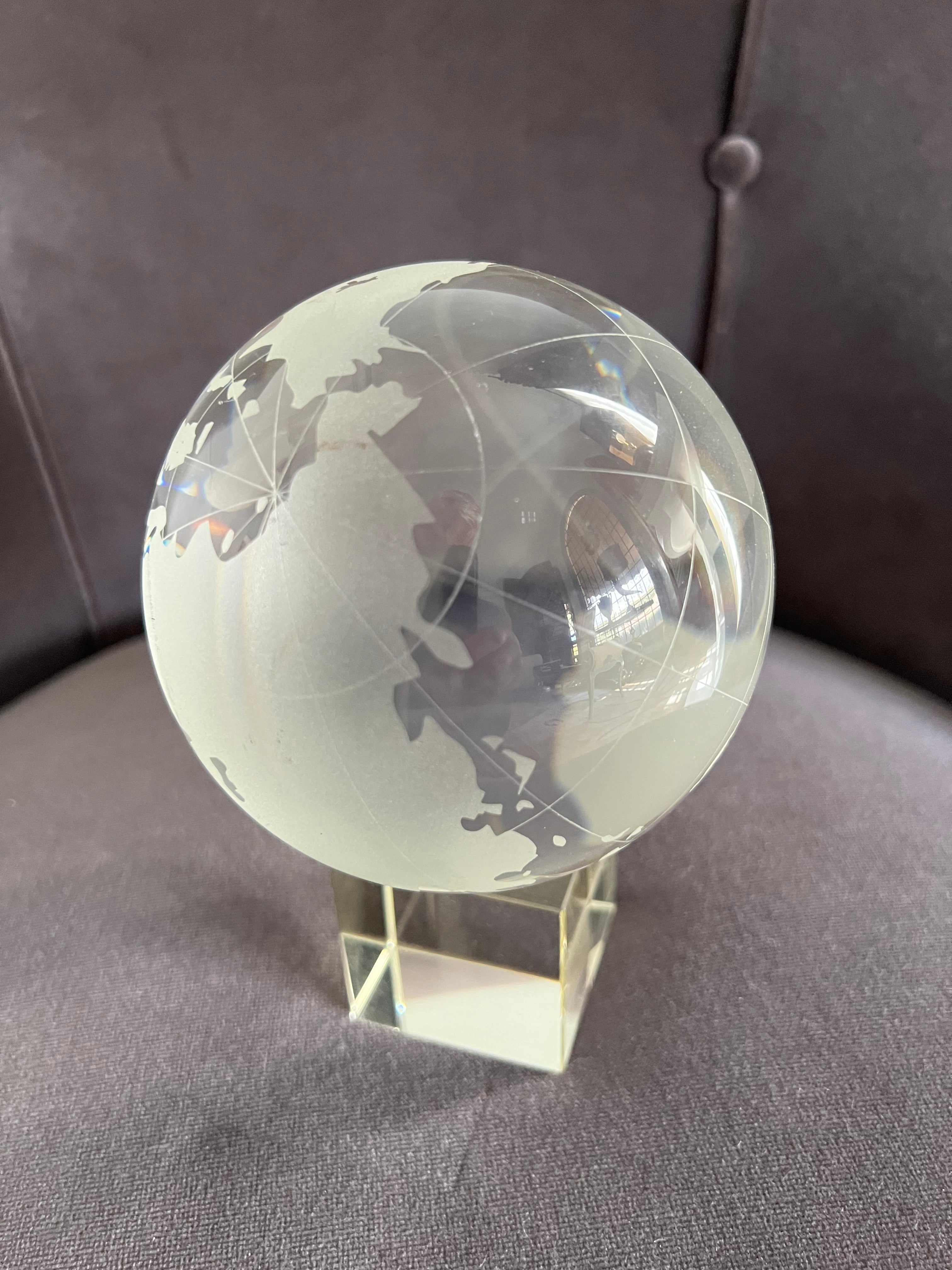 
Art Glass Globe of the world.   A beautiful globe with etched continents against oceans of crystal glass. This globe sits atop a 2