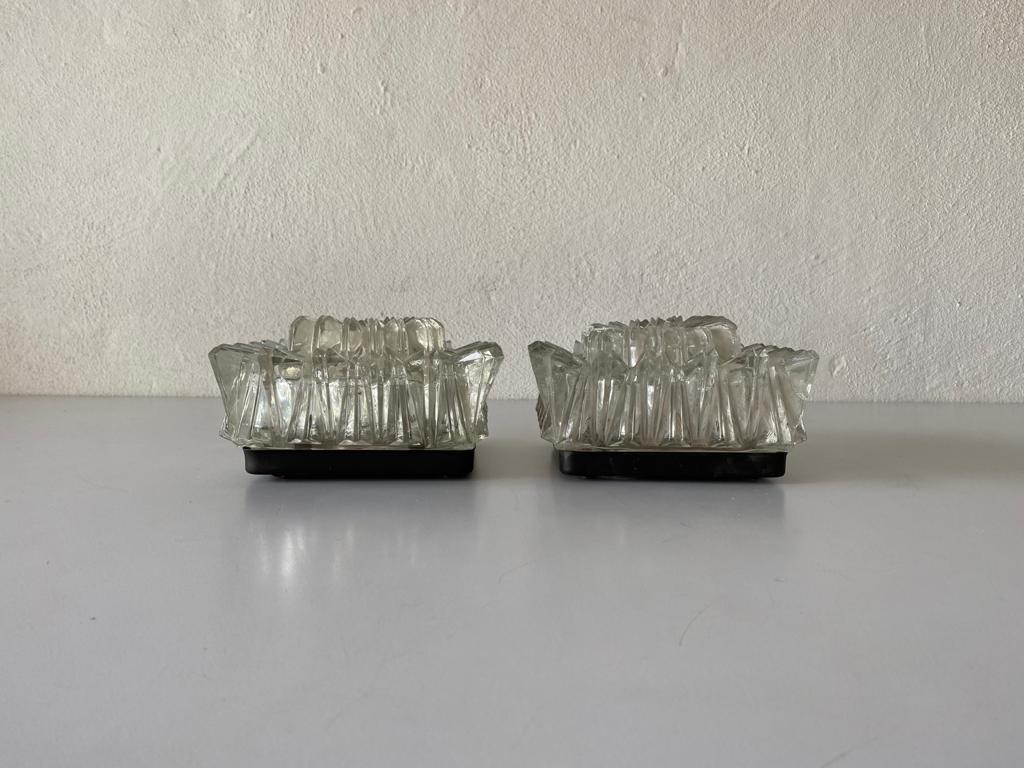 Crystal glass pair of sconces or ceiling lamps by Limburg, 1960s Germany

Very nice high quality wall lamps.

Lamps are in very good vintage condition.

These lamps works with E14 standard light bulbs. 
Wired and suitable to use in all