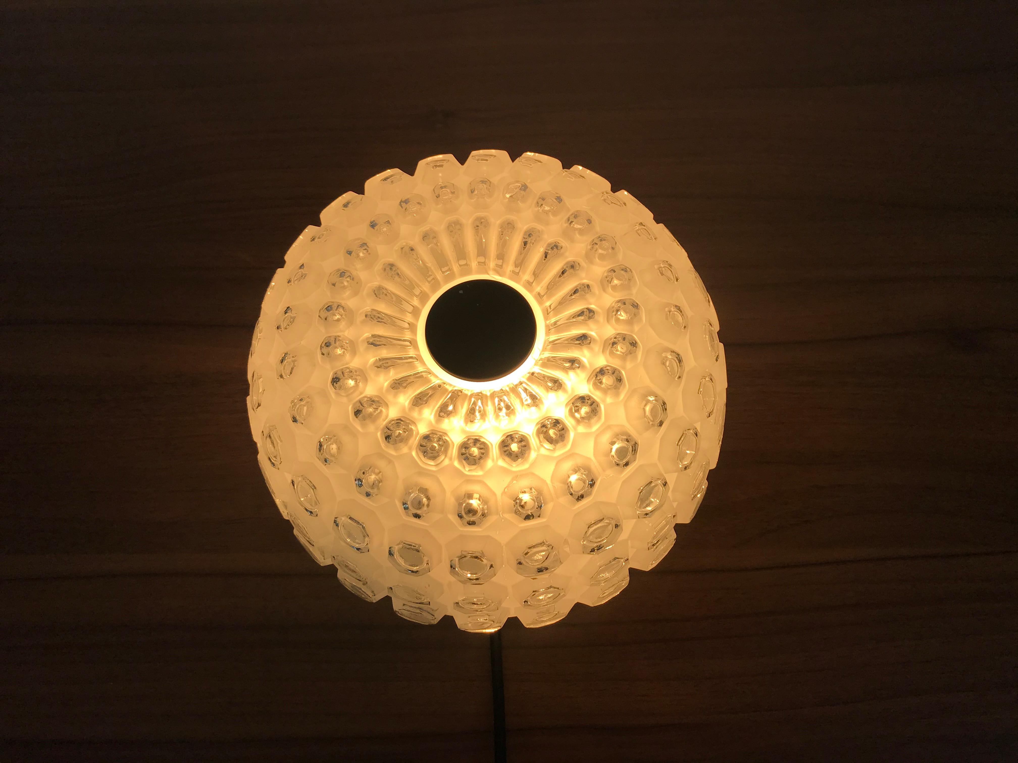 Flush mount by Glashütte Limburg made in Germany in the 1960s. It is fascinating with its crystal glass, which is typical for the German brand. The round top of the light is made of aluminum.

The light requires one E27 light bulb.