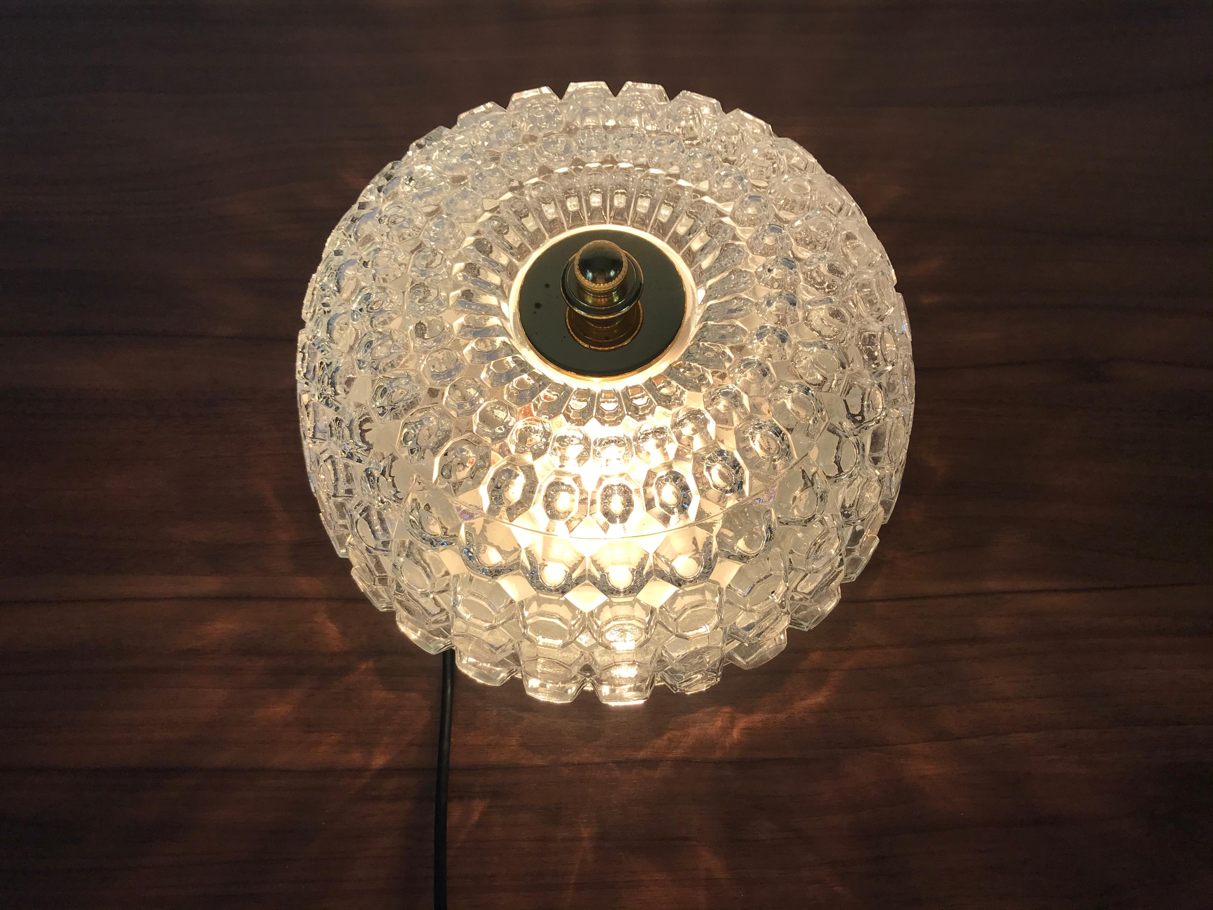 Flush mount by Glashütte Limburg made in Germany in the 1960s. It is fascinating with its crystal glass, which is typical for the German brand. The round top of the light is made of brass.

The light requires two E27 light bulbs.