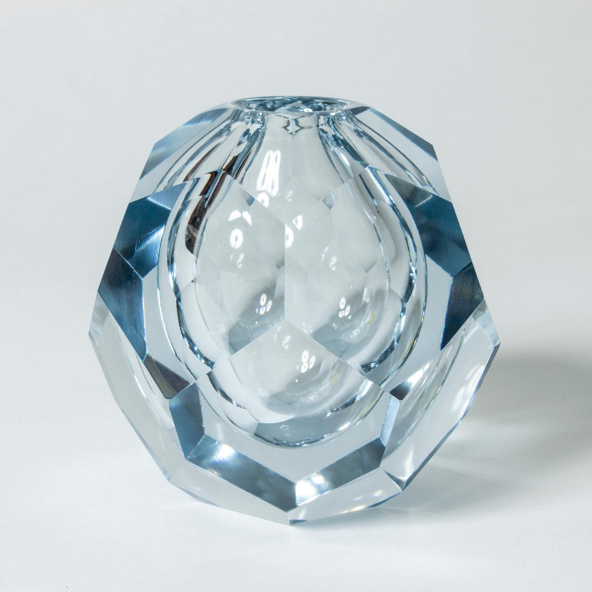 Crystal “Prisma” vase by Asta Strömberg, in heavy quality and a pale blue tone. Cut with numerous smooth facets that create a striking, melting ice effect.