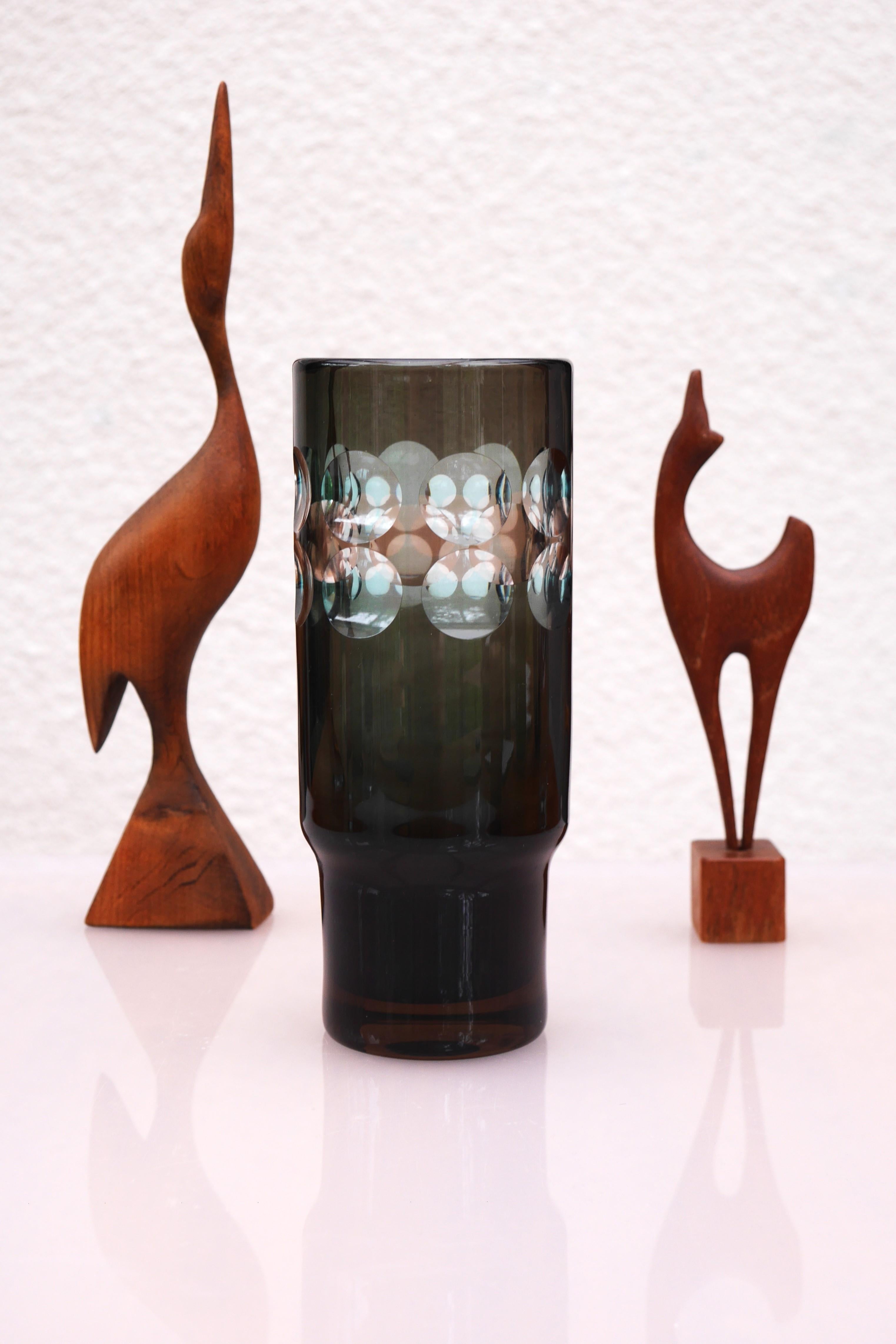 A very special and sophisticated signed and handmade glass vase made by the talented designer Ove Sandberg for Kosta Boda, Sweden. His work always has a special edge to them. The vase is simple in the form in a dark green color, with several