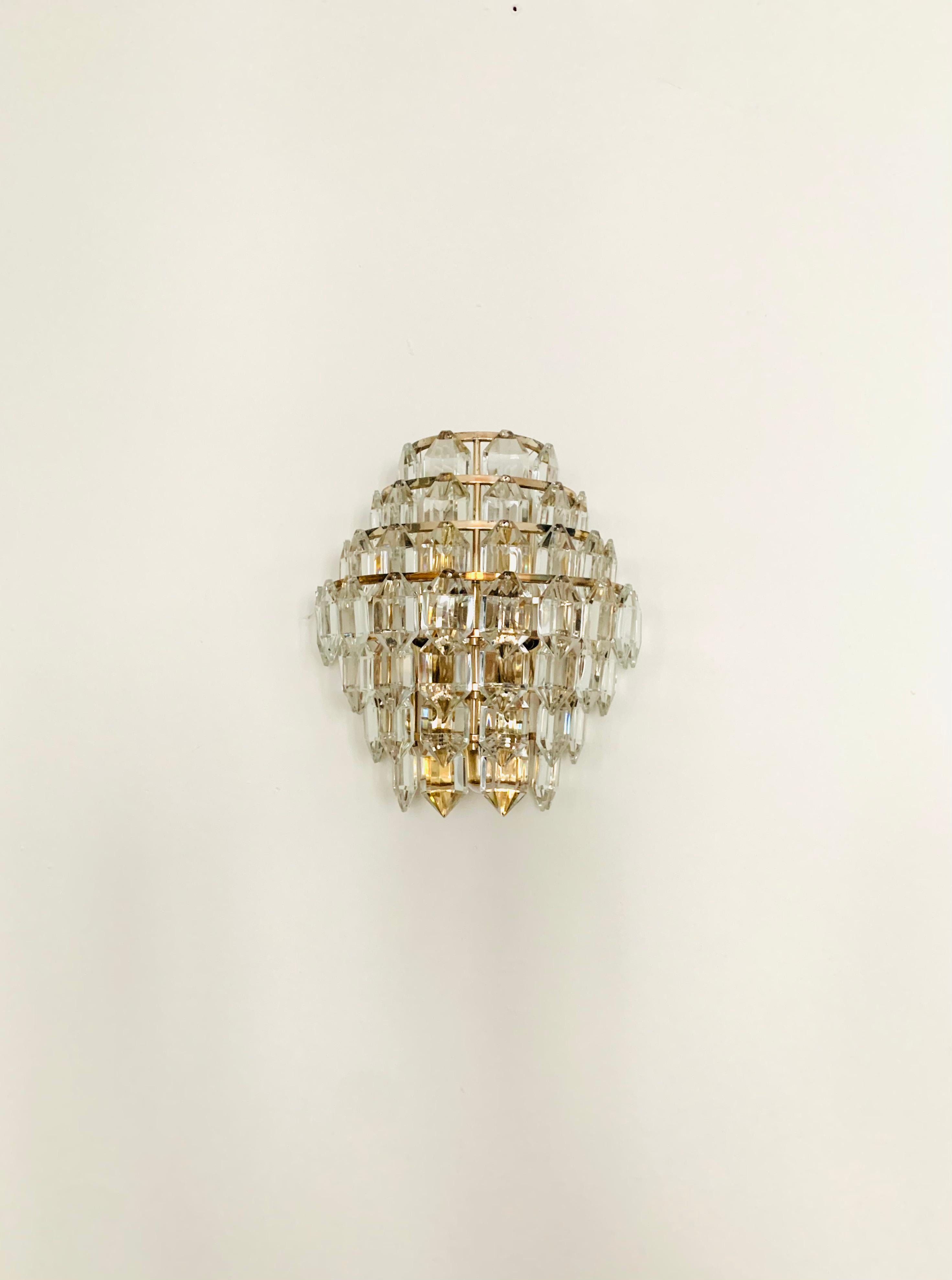 Very beautiful and rare wall lamp from the 1960s.
Very pleasant lighting effect due to the crystal glass, which spreads an elegant, sparkling play of light in the room.
Excitingly beautiful design and high-quality workmanship.

Manufacturer: