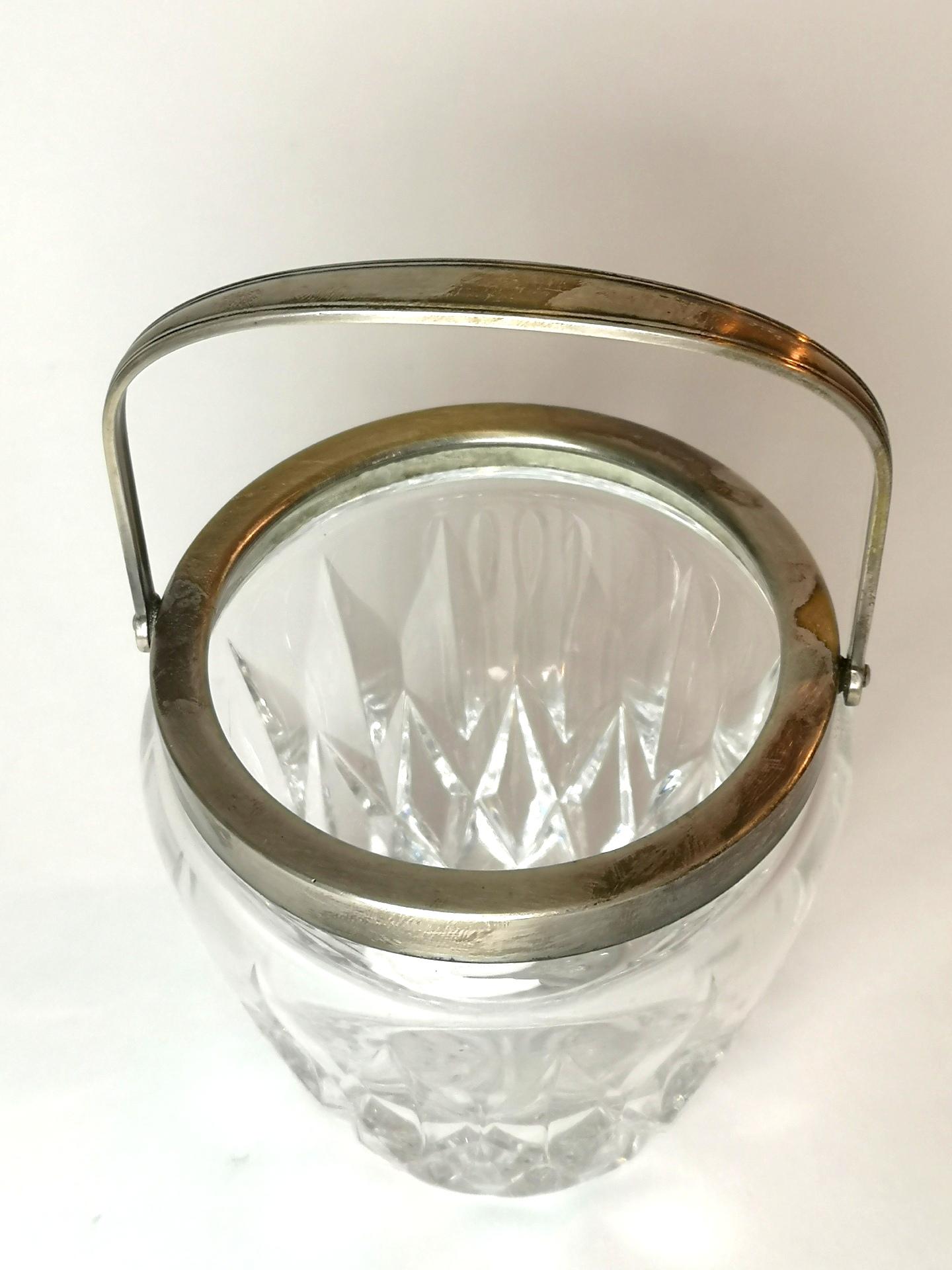 Silver plated brass handle and chiseled crystal glass are the main features of the small ice bucket. This glass piece was made in the 1970s by WMF and is in good condition.
This item comes professionally packaged, thoroughly wrapped in paper,