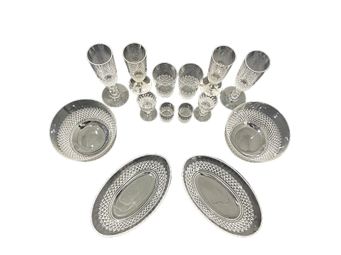 Crystal Glasses of 14 Pieces, 2 glasses with silver foot, set for 2

An english set of crystal glasses with diamond cut and oval pattern. 
Mid-20th century. 
2 pieces of small water or lemonade glasses of 8,5 cm high and 5.5 cm diagonal
2