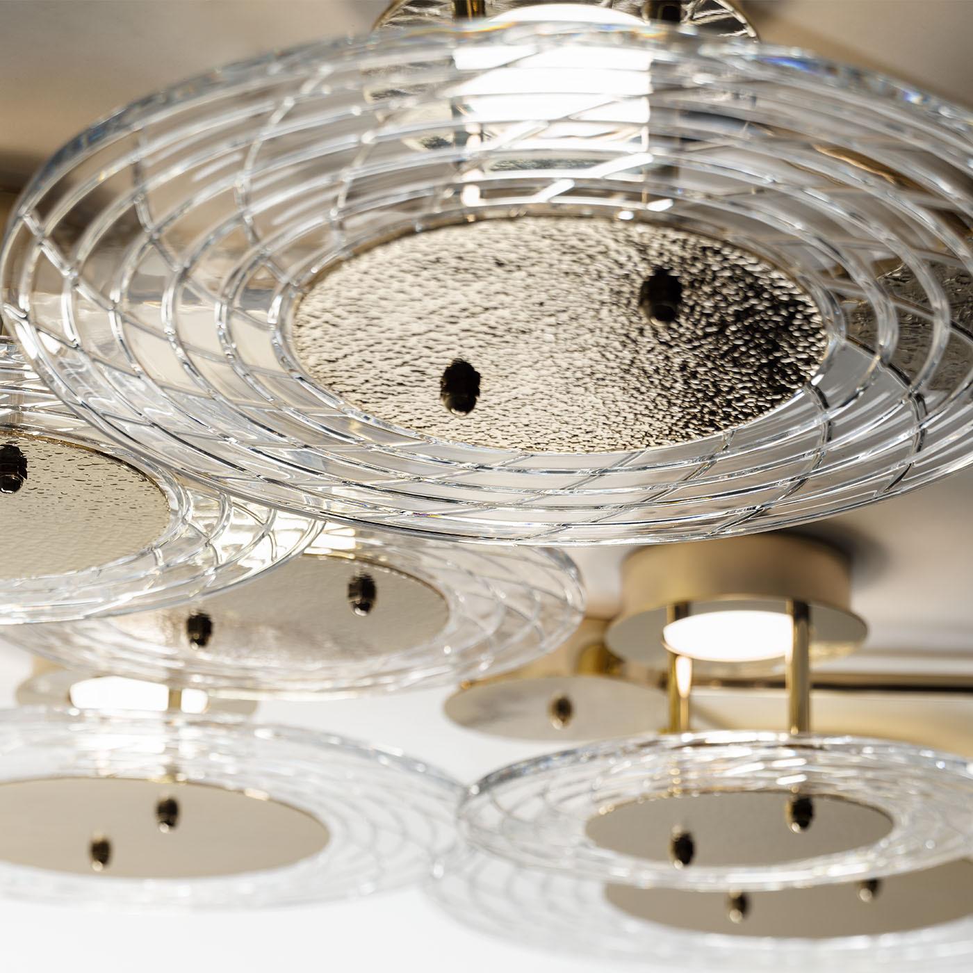 Crafted with intricately designed crystal, this ceiling lamp features a distinctive hammered effect that adds depth and character to its aesthetic. Each detail of this piece has been meticulously designed, ensuring that elegance and refinement are