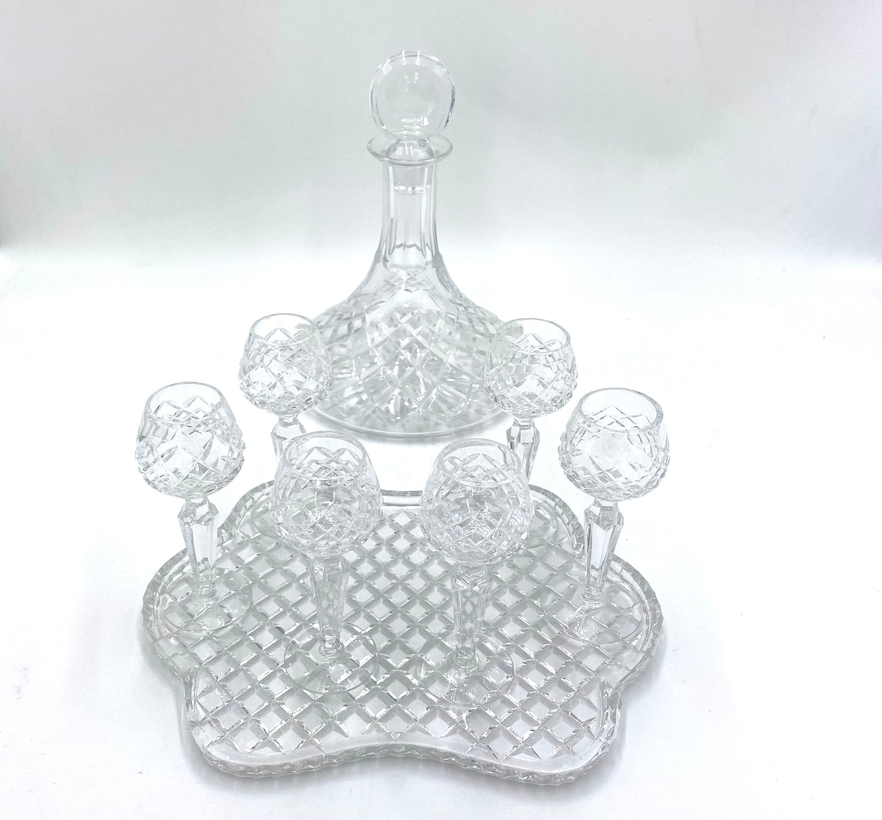 Crystal liqueur set consisting of a decanter with stopper, 6 liqueur glasses and a tray

Made of colorless crystal

The set was made in Poland in the middle of the 20th century

Very good condition

carafe: height 26cm, diameter
