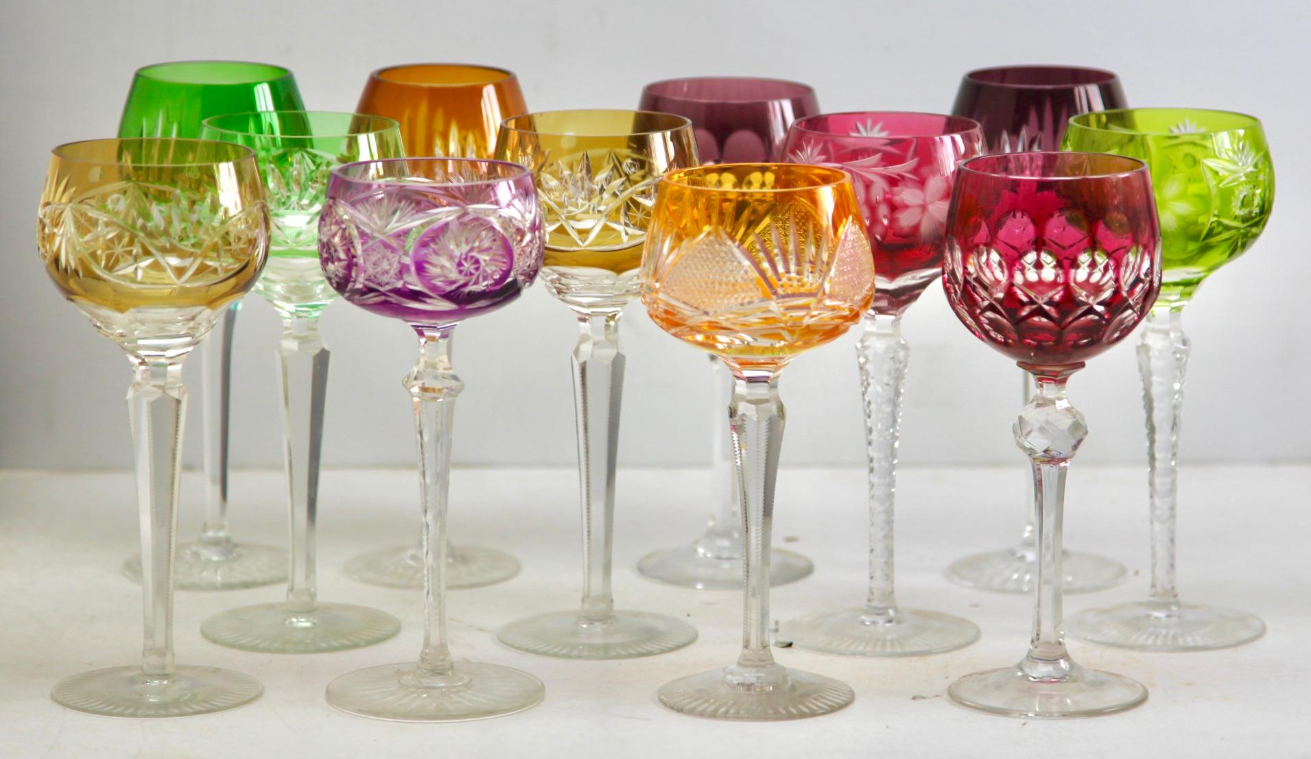 Vintage mix set of 12 cut to clear crystal stem glasses. + 6 water glasses 
Mix crystal (Bleikristall 24% Mundgeblasen Handgeschliffen) glasses

Clear demi crystal glass. Side facetted and toothed stem. The bowl with a coloured overlay cut to