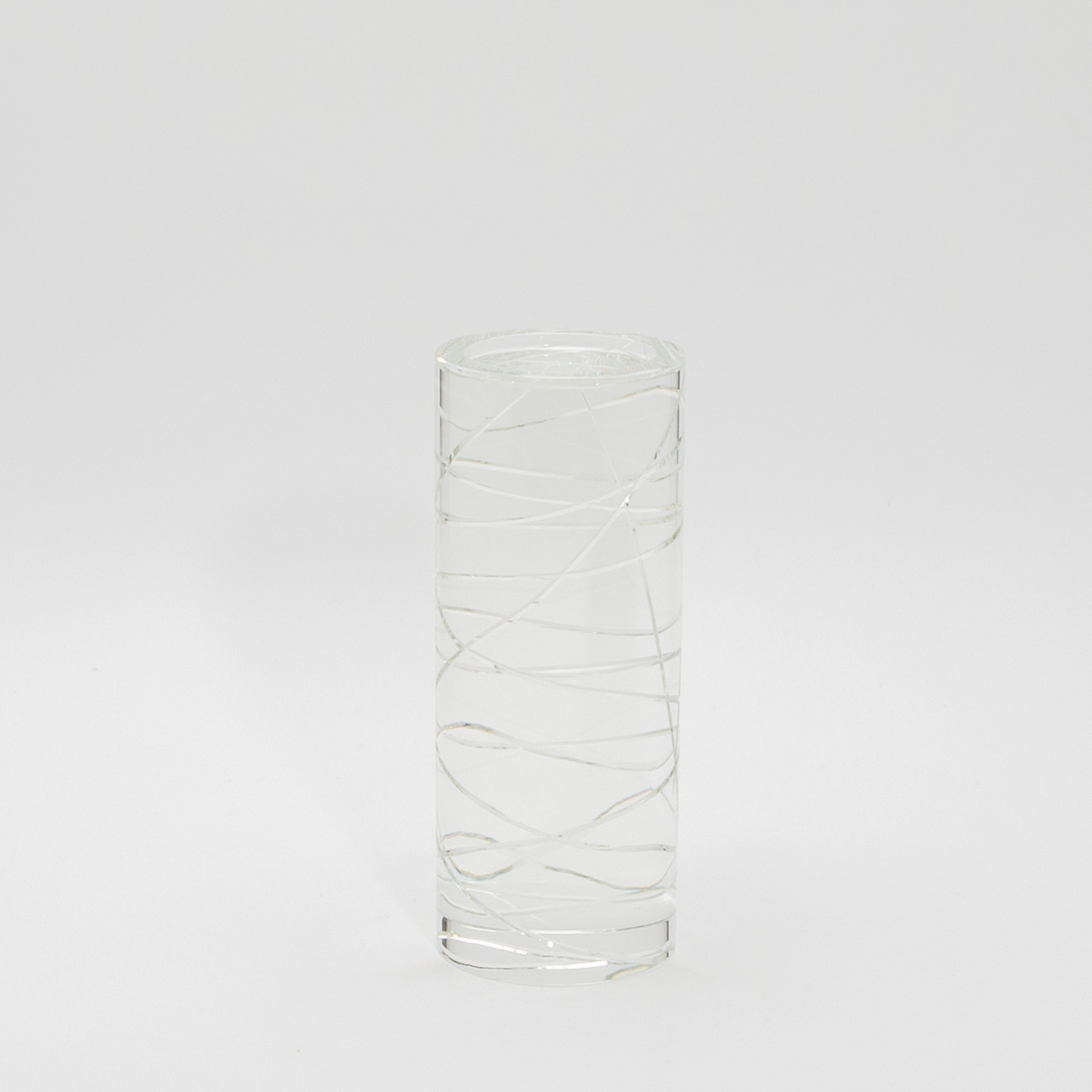 The Chaos Pillar by KA Glass is a stunning embodiment of craftsmanship and artistry, made from meticulously hand-crafted crystal glass. This exquisite pillar candle holder captivates with its bold, sculptural form, where fluid lines and geometric