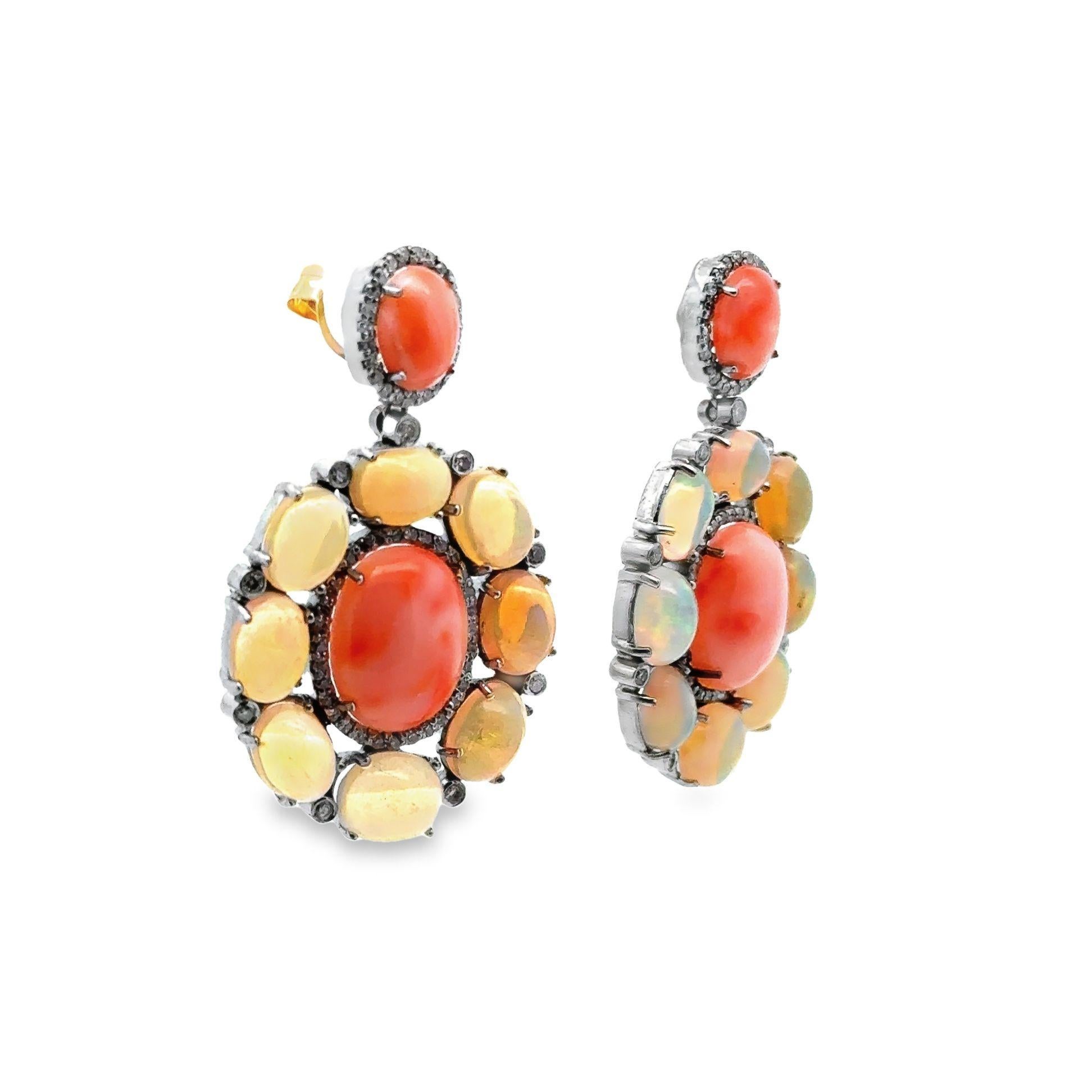Indulge in the enchanting beauty of these dangle earrings, adorned with crystal opals, vibrant pinkish-orange coral, and sparkling diamonds! The mesmerizing play of colors in the halo of opals evoke a sense of mystique and allure. Paired with the