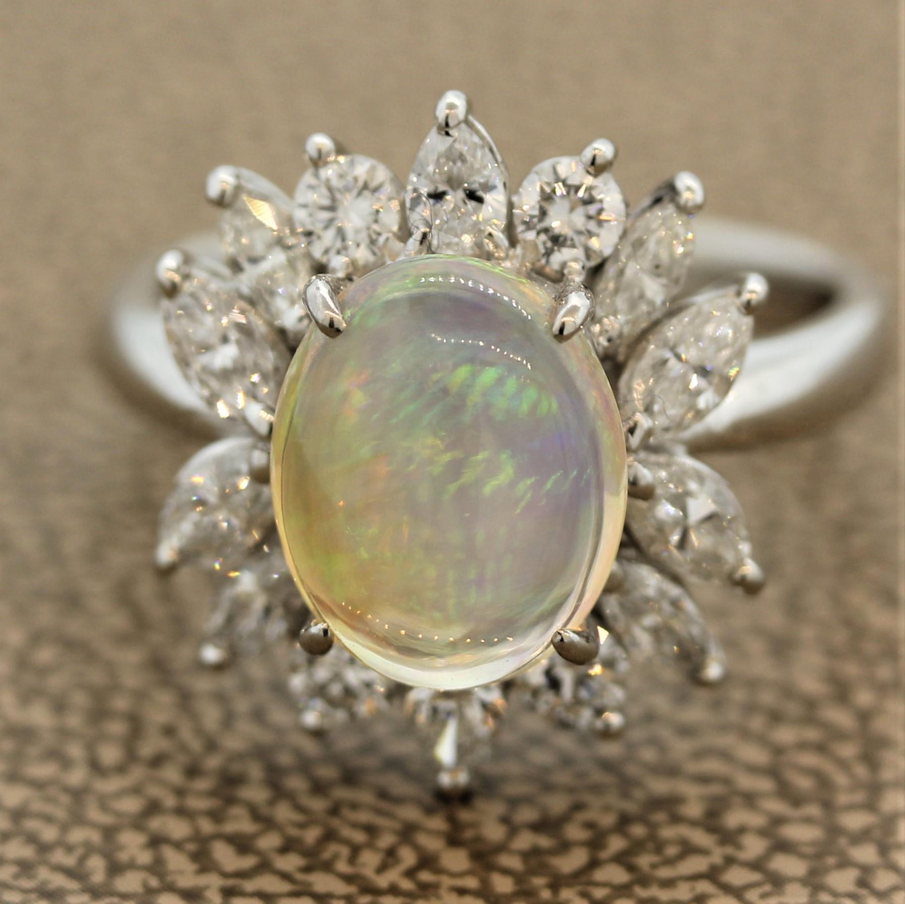 A ring featuring a bright crystal opal with amazing play-of-color. The 2.23 carat opal shows bright flashes of red, orange, green, yellow, and blue; which all roll and shine across the surface of the opal. It is surrounded by 1.12 carats of marquise