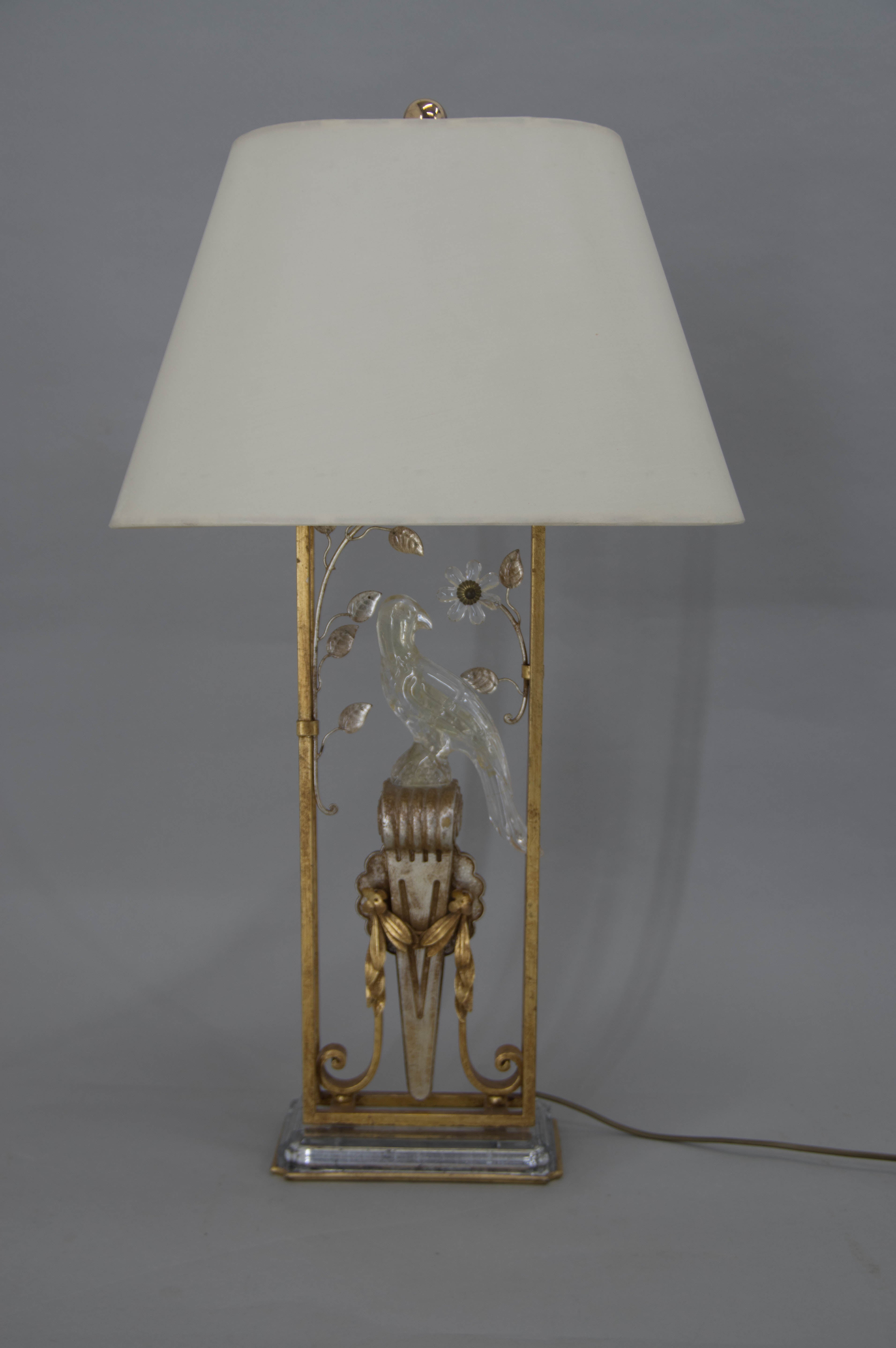 Beautiful big table lamp with crystal parrot and leaves with fabric shade.
Attributed to Maison Begués.
Original condition. 
The shade has traces of liquid on one side, the other side is perfect.
One crystal leaf has broken top visible on
