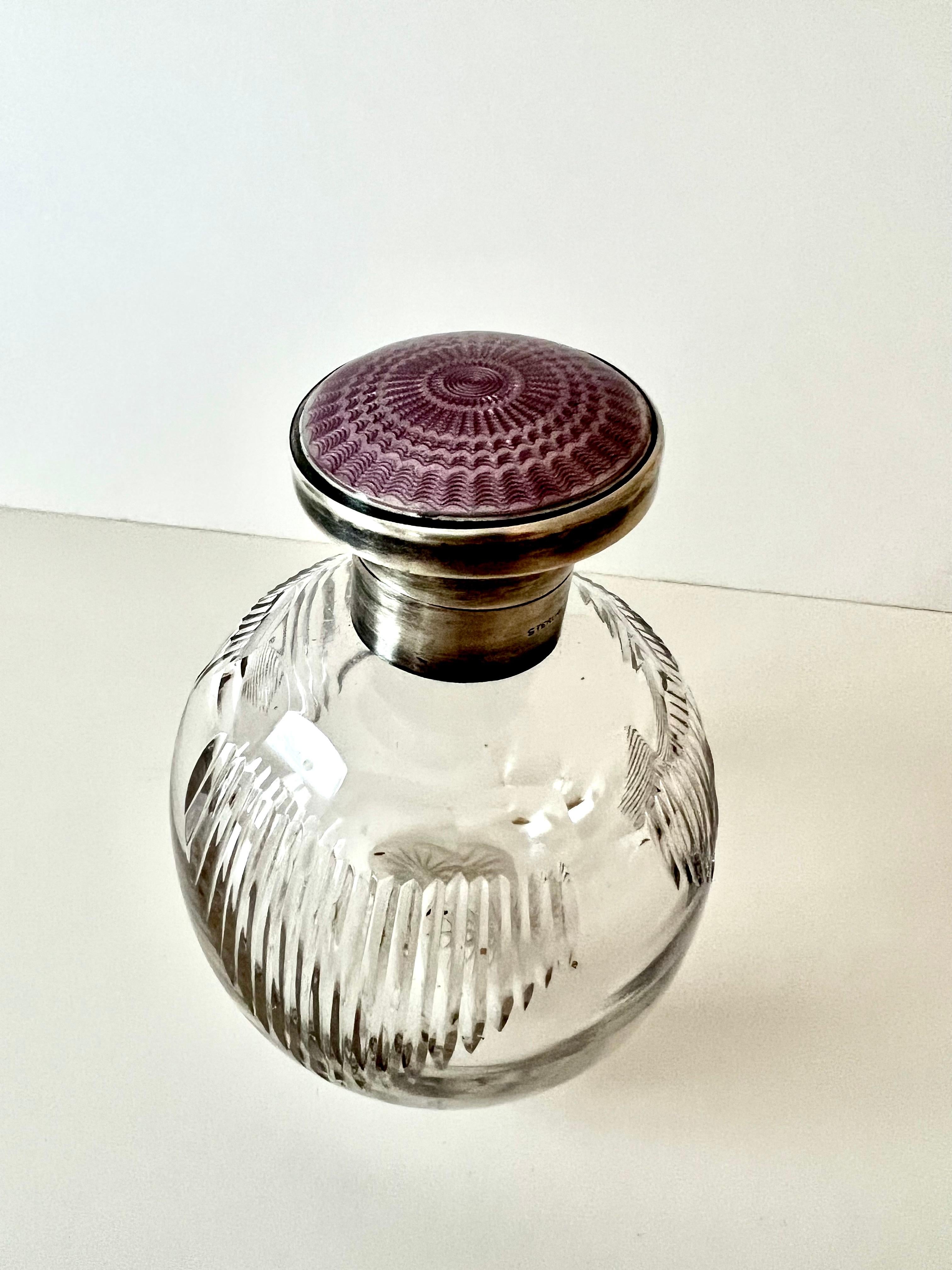 A beautiful perfume bottle with sterling closure and Lavender Enamel Guilloché. A compliment to any dressing table, dressing room, vanity or near the tub... a gorgeous clear glass piece with no staining. The enamel Guilloché is stunning.