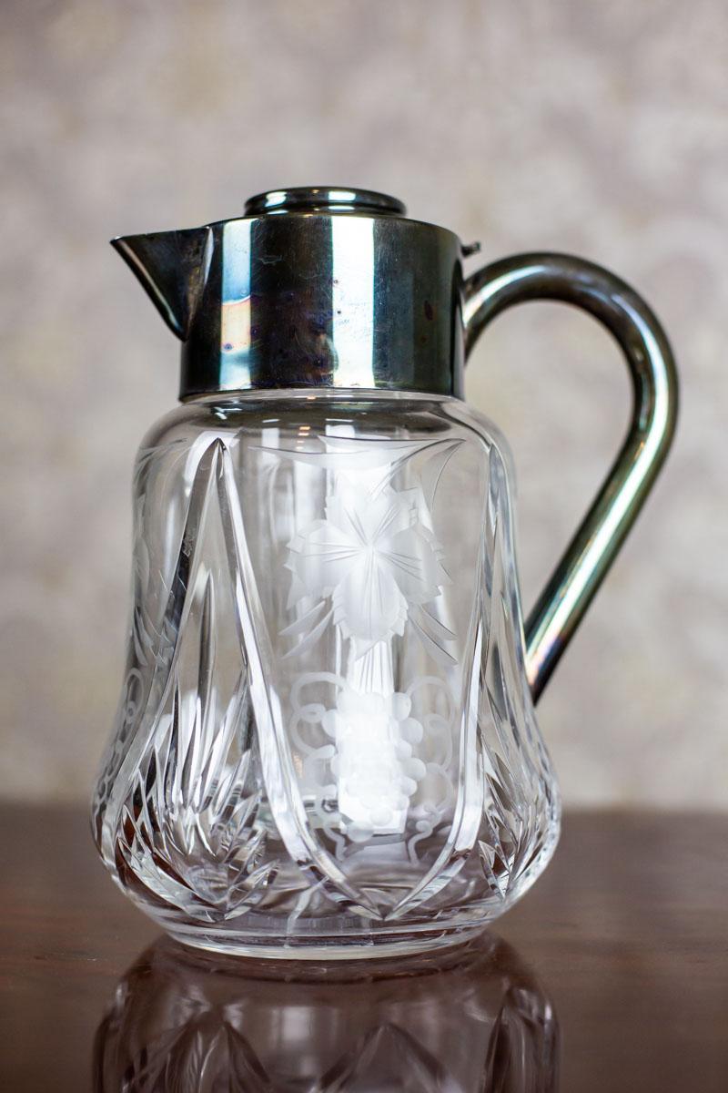 We present you a crystal pitcher with a hand-engraved pattern, fitted in silvered metal. The item is from the Interwar Period.
There is a removable insert for ice inside.

This pitcher is in perfect condition and undamaged.