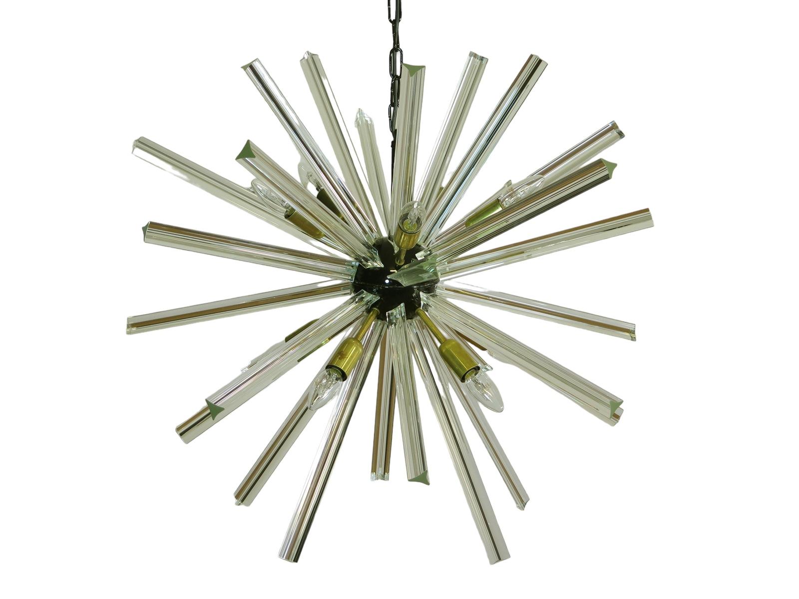 Sputnik chandelier surrounding 30 crystal glass 'triedri' prisms radiating from a center black metal nucleus. Brass lamp holder.
Period: late xx century
Dimensions: 47,25 inches (120 cm) height with chain; 29,50 inches (75 cm) diameter.
Dimension