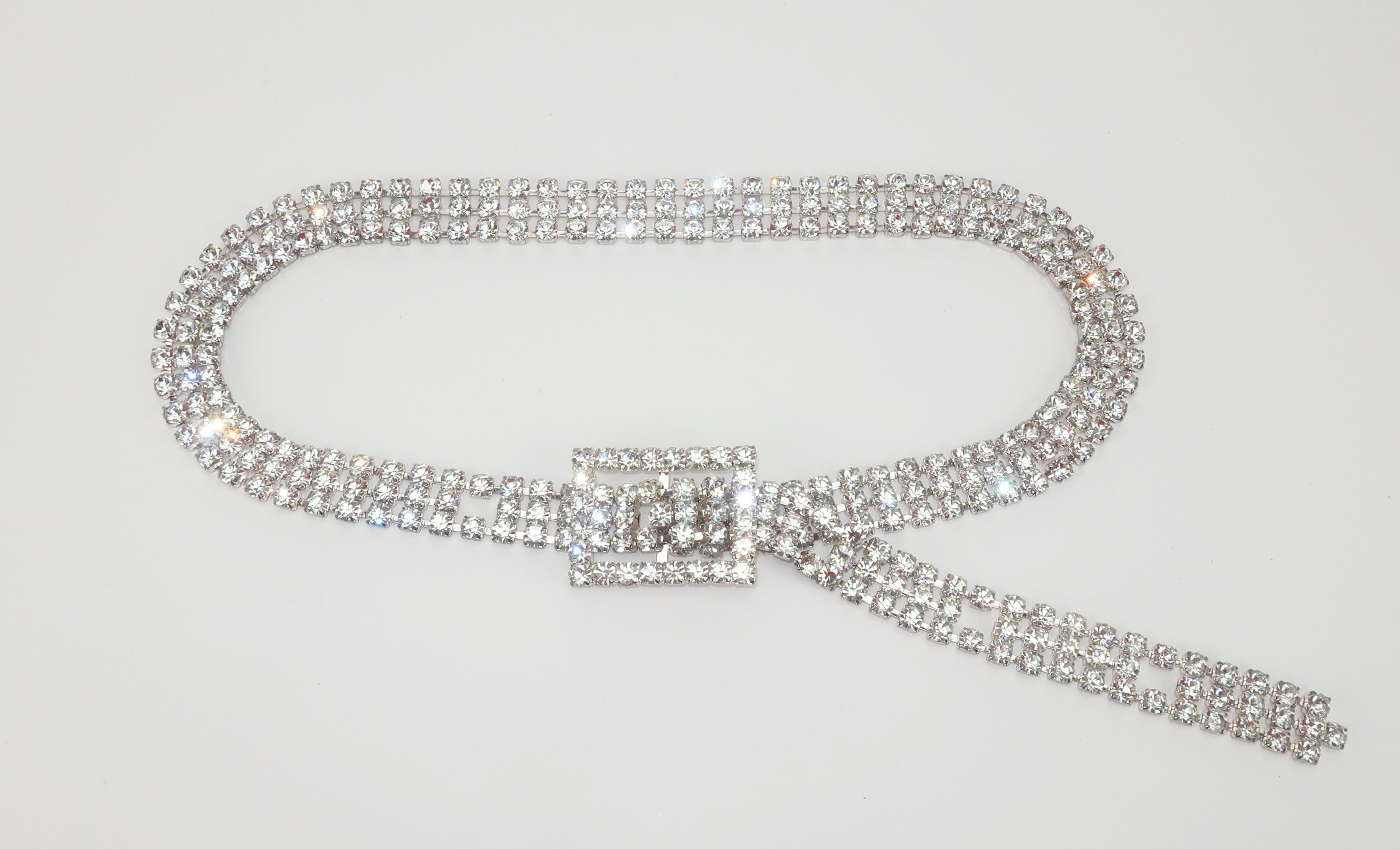 1970's disco glam crystal rhinestone belt with five adjustable sizes.  The articulated rhinestones are set in a silver tone metal providing the belt a slinky and serpentine like quality which is fun for swagging across the hips.  Pair the belt with