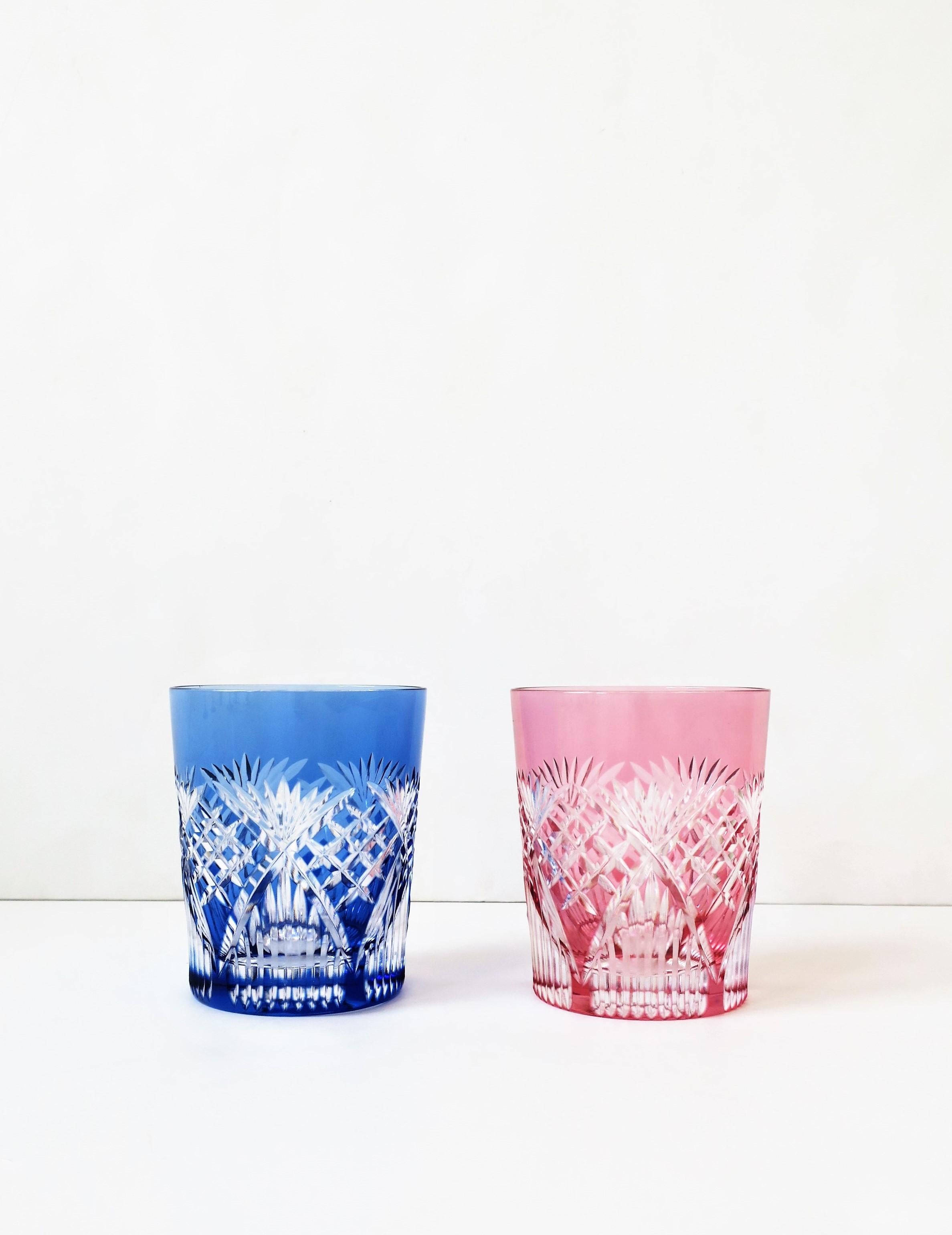 A very beautiful set of two (2) handcrafted cut crystal rocks' cocktail or whisky/whiskey glasses from luxury maker Kagami, Japan, circa 21st century. Beautiful handmade cut crystal rocks glasses in blue/clear and pink/clear. A great set for