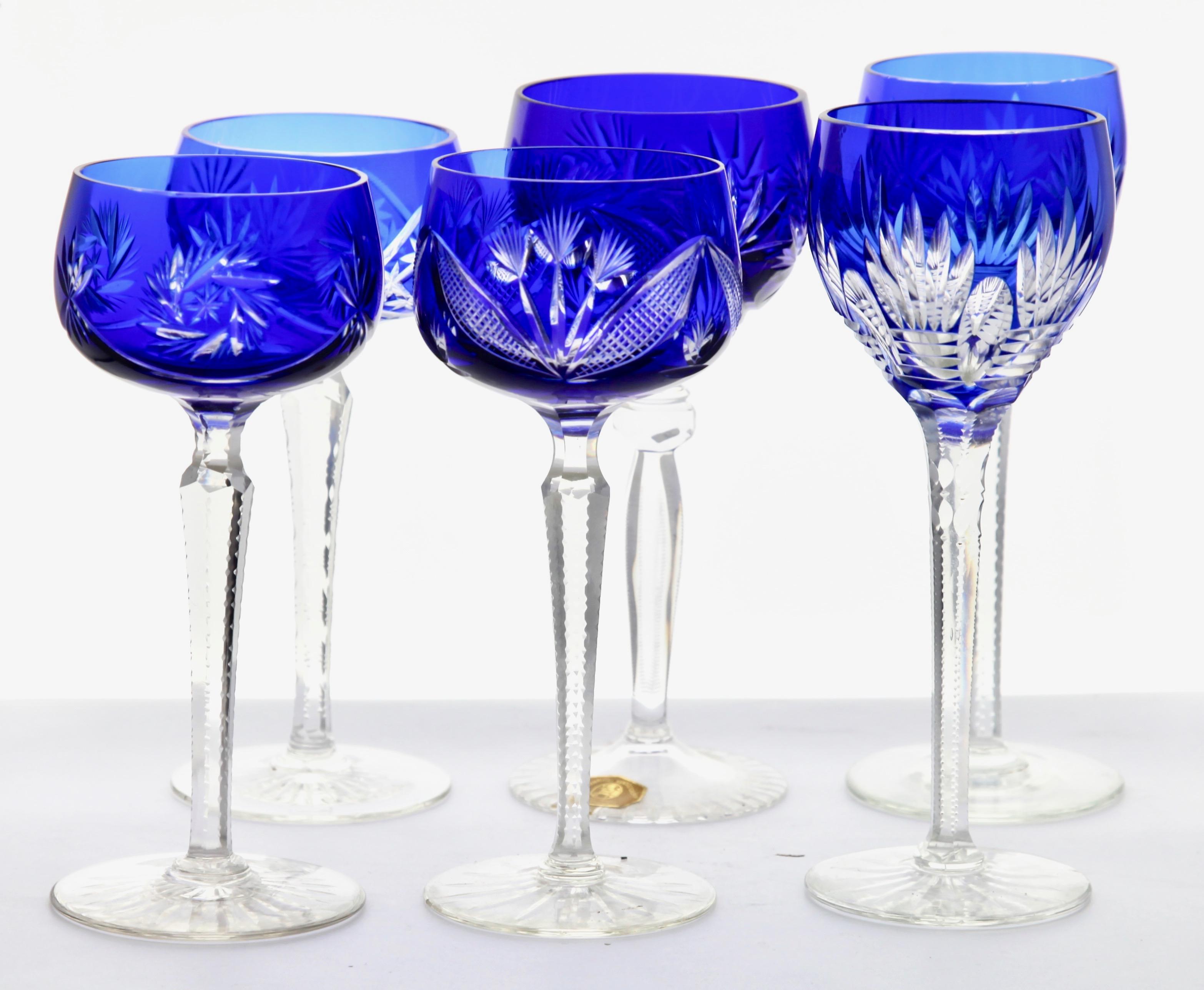 Vintage of 6 cut to clear crystal stem glasses in cobalt blue, 1960s
Clear crystal glass. Six sides facetted and toothed stem. The bowl with a cobalt blue overlay cut to clear.
 In the best condition.

We specialise in Art Nouveau, Art Deco and
