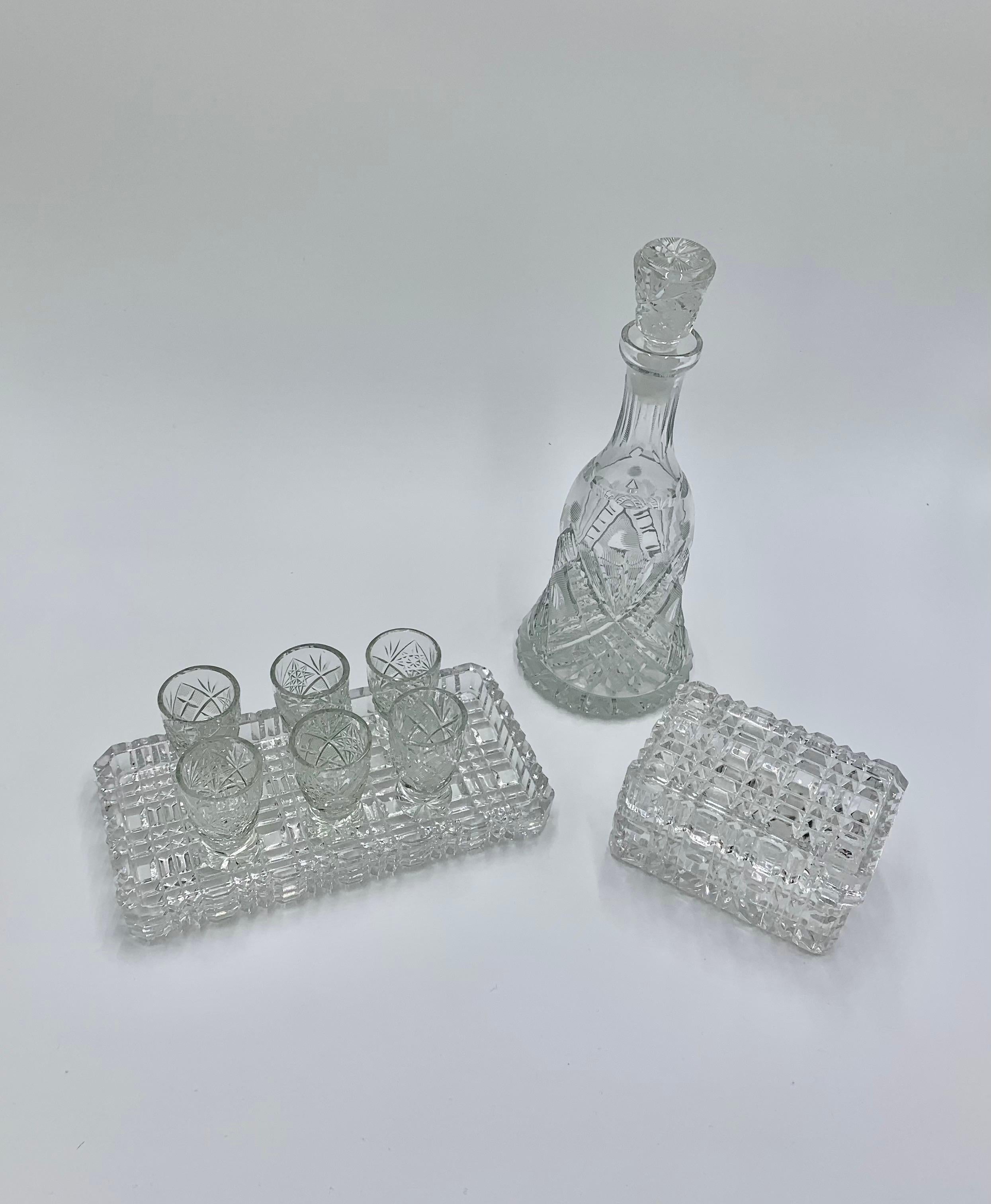 Set of 3 crystal clear items - decanter, small glasses on tray and casket.
Made in Poland in middle XX century
Very good condition 
Decanter : height 27cm diameter 9cm
Tray : width 21 x 12 cm
Casket : height 7 cm , width 13cmx9cm.
