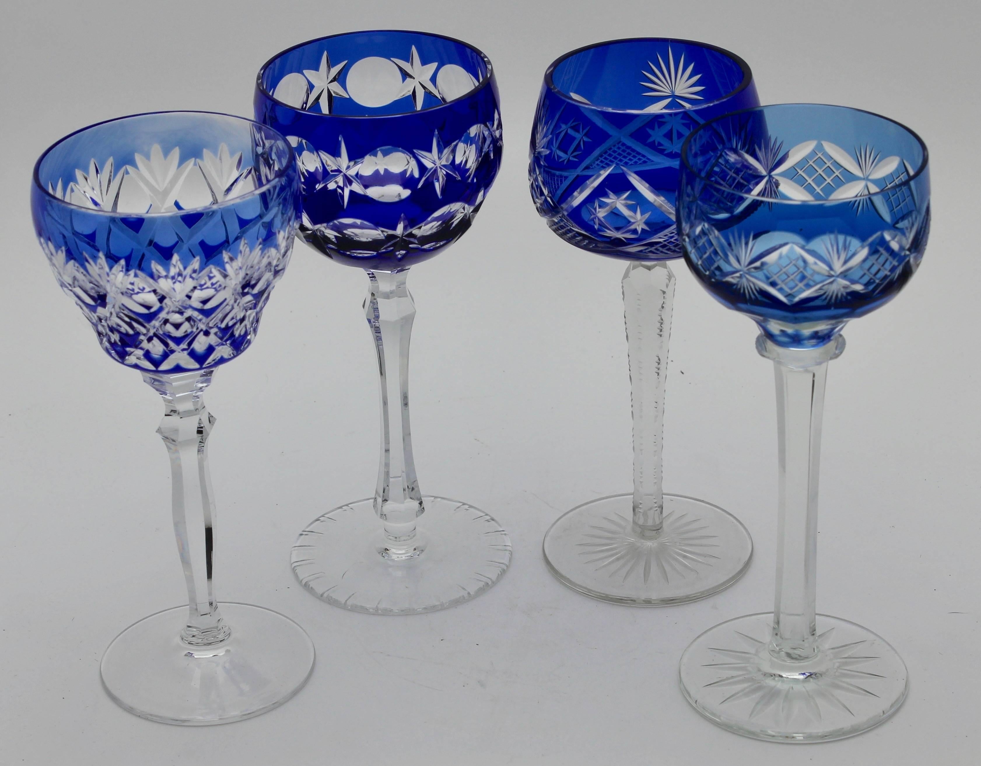 Multicolored set of 16 cut to clear crystal stem glasses.

Clear demi crystal glass. Six side facetted and toothed stem. The bowl with colored overlay cut to clear. 
VEB Lausitz glassworks GDR 1965s. In best condition.
 