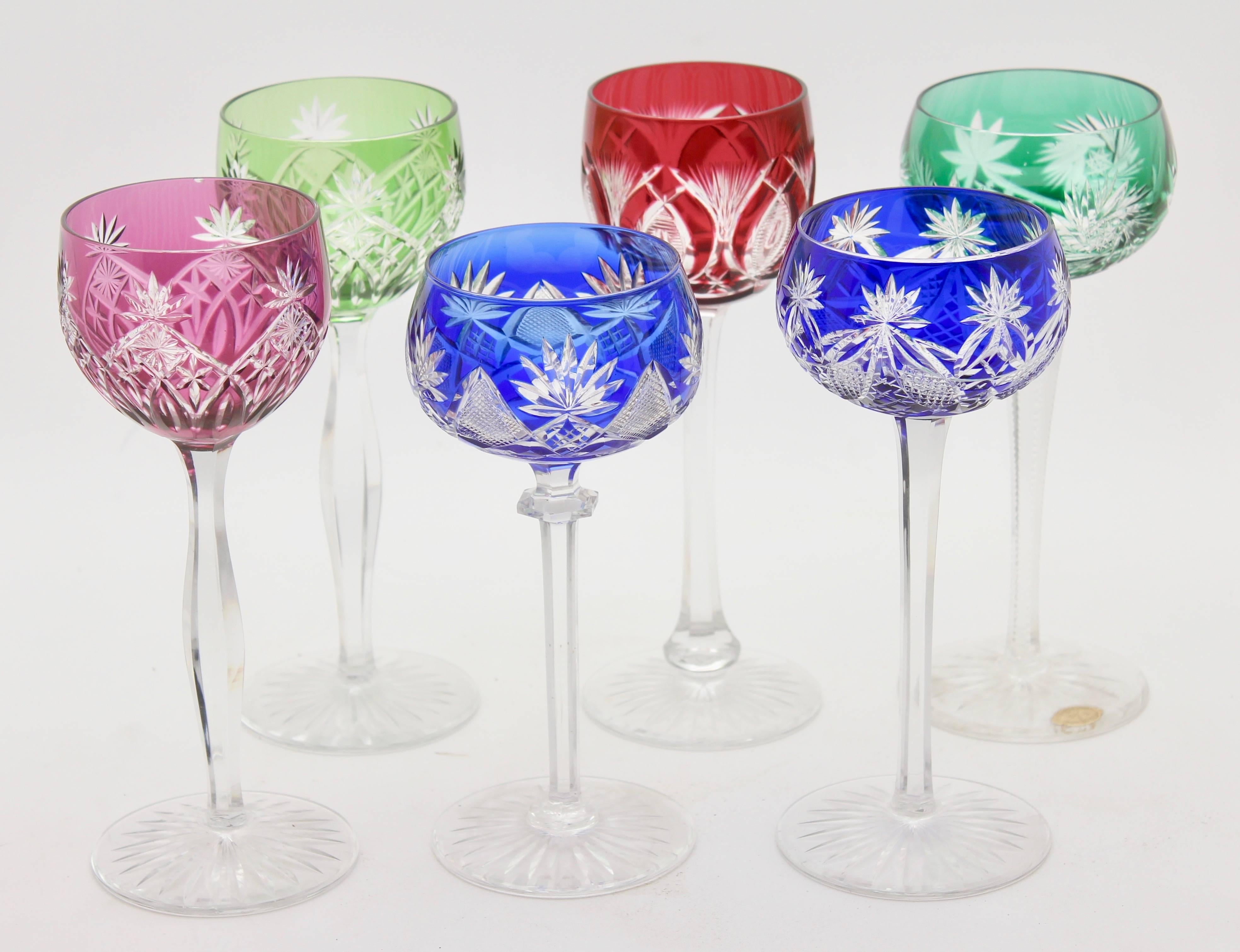 Vintage set of six cut to clear crystal stem glasses.

Clear demi crystal glass. Six side facetted and toothed stem. The bowl with colored overlay cut to clear. 
VEB Lausitz Glassworks GDR 1965s. In best condition.
 