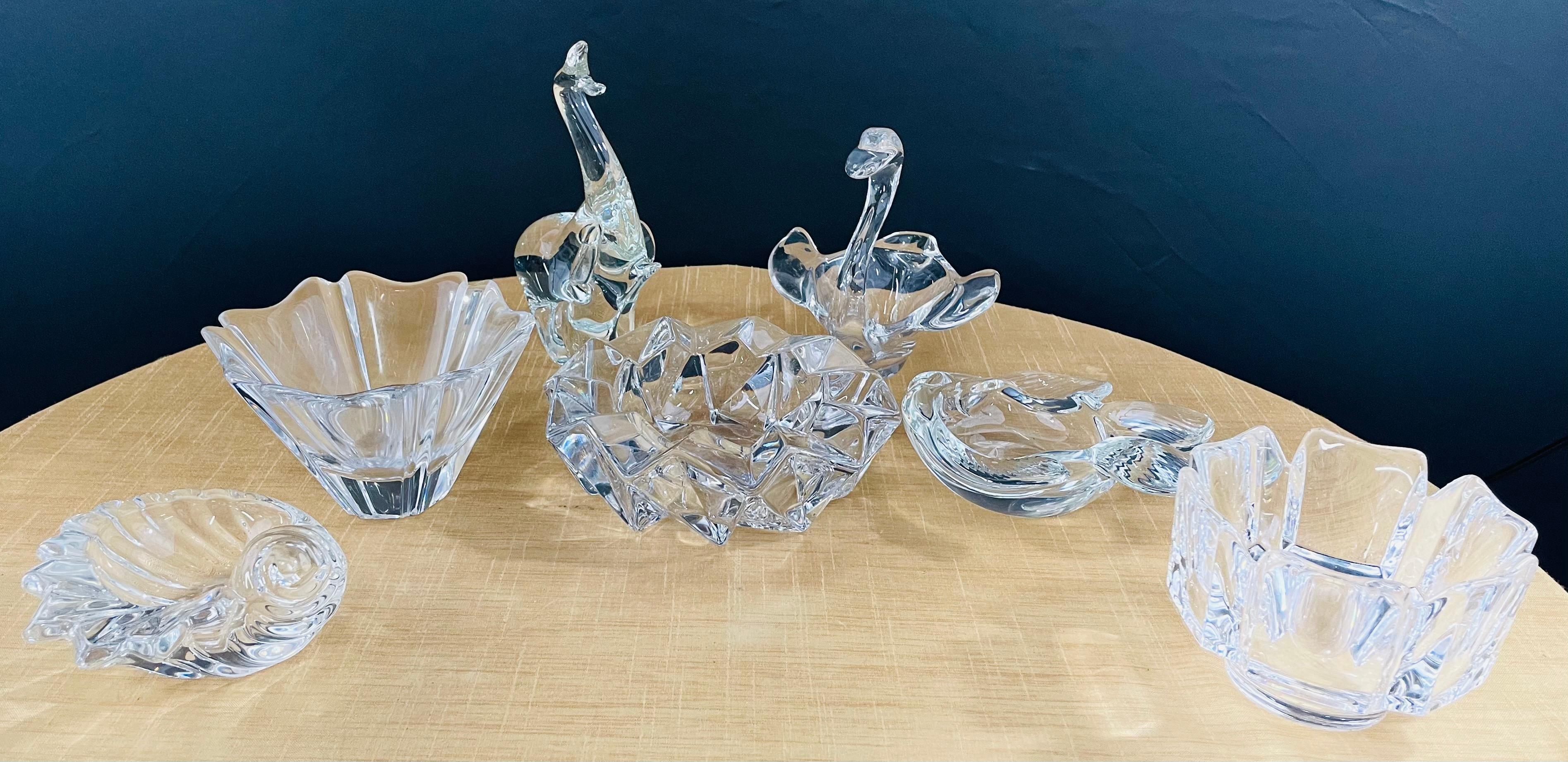 A set of 7 crystal small dishes, that can also be used as ashtrays. Each differs in shape and some pieces are shaped as animals and sea species. The set of crystals can be used to store items if needed while decorate your desk or shelves.