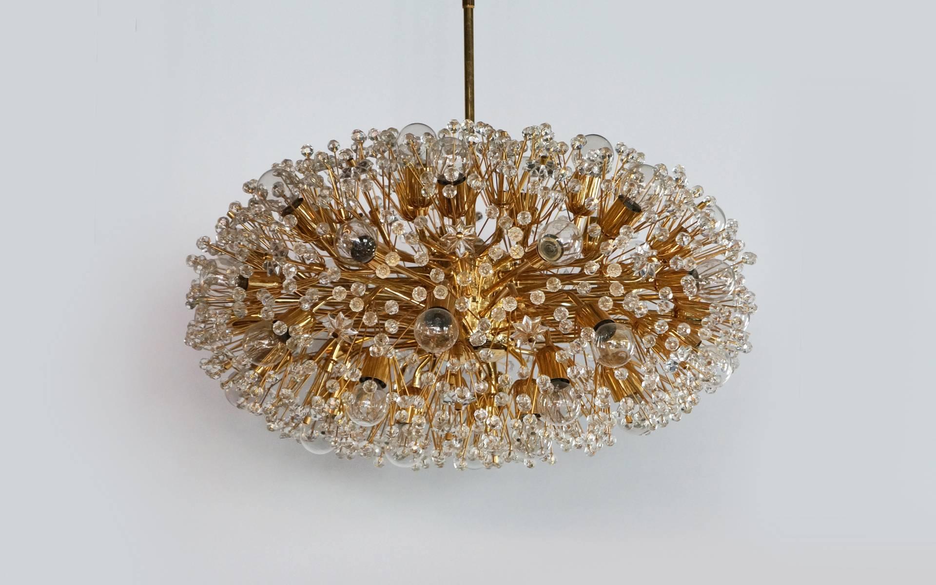 Oval / saucer shaped chandelier designed by Emil Stejnar and made in Vienna by Rupert Nikoli. This is a 24-carat gold-plated fixture covered with Austrian crystal balls and stars. There are more than 30 sockets filled with Edison bulbs. This is a