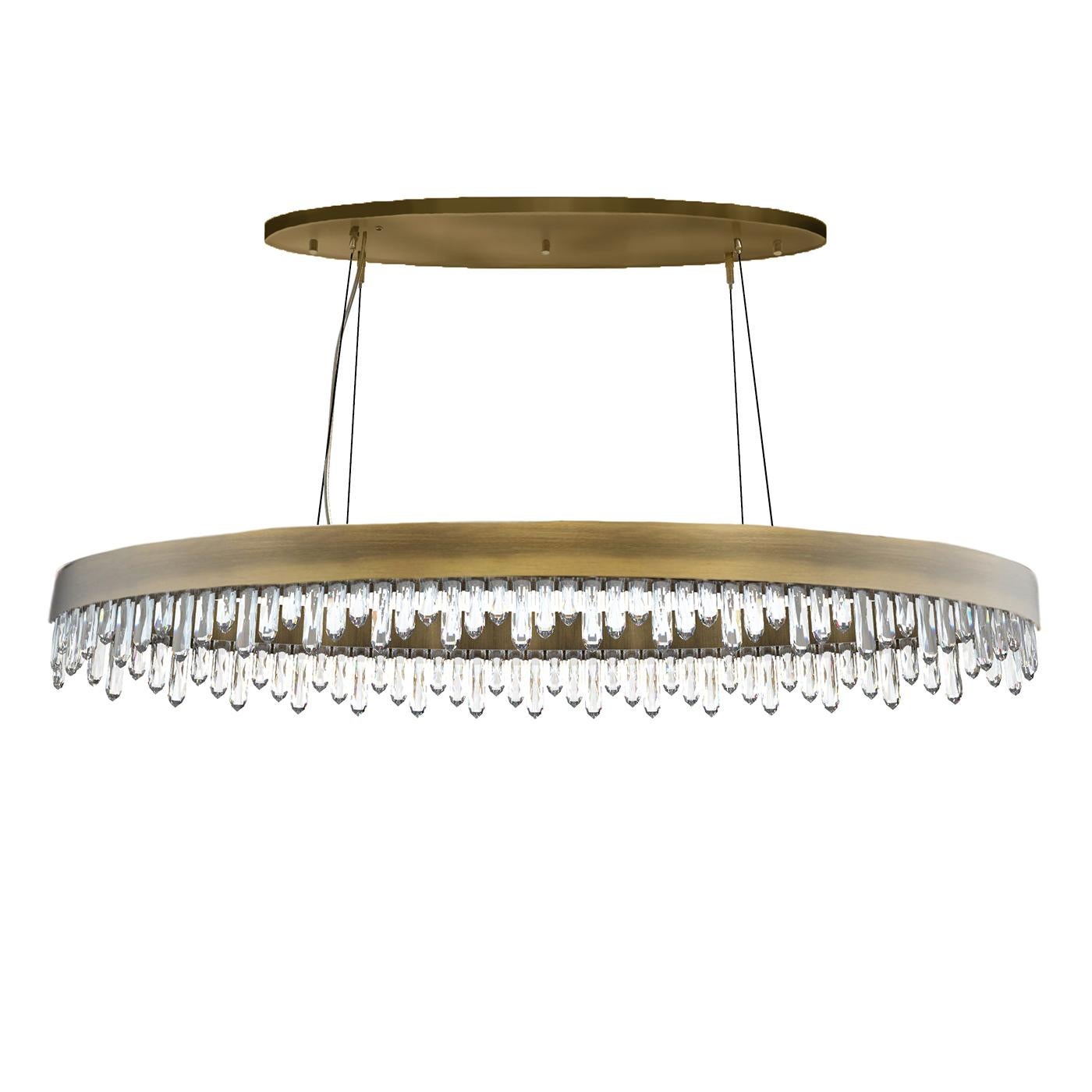 Suspension crystal sticks oval with carved quartz 
crystal sticks. Structure in solid brass in antique brushed 
finish. With led light included inside the ring structure.