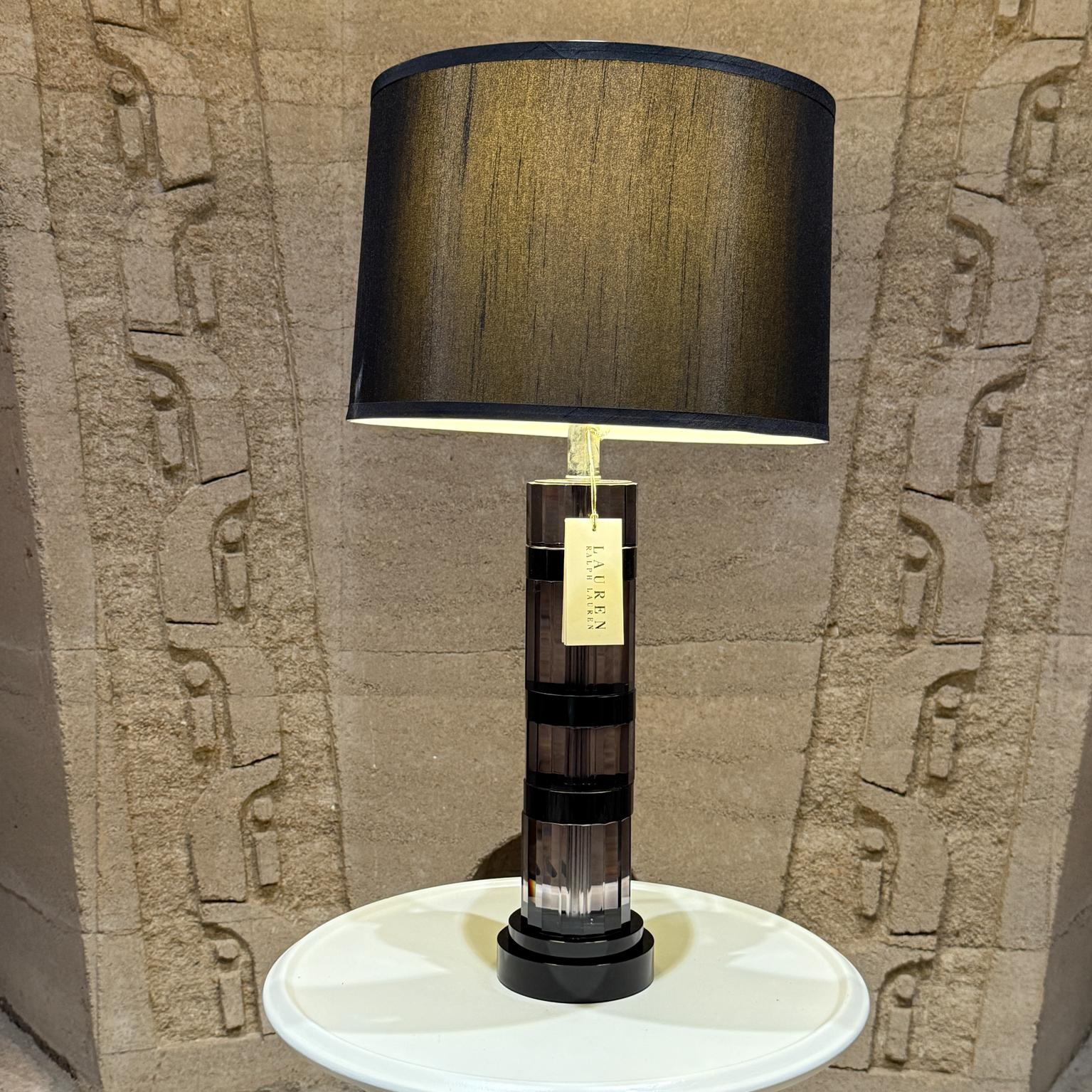 For your consideration, a beautiful crystal table lamp by Ralph Lauren. Lamp includes the hard and black shade. Smoke color with chrome. Black satin shade. Retains original Lauren label. Stamped Lauren on the base.

Dimensions: 20.75 H x 5 Diameter.