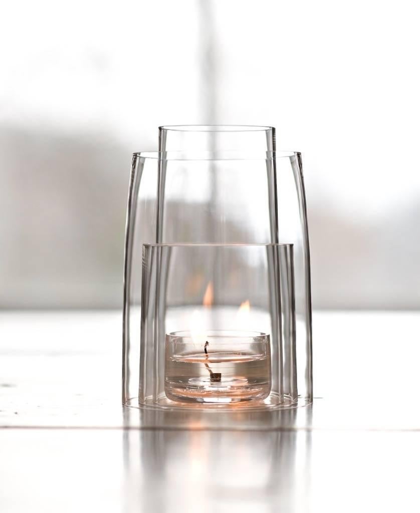 Deborah Ehrlich's crystal tea light hurricane lantern is made up of four nested pieces of handblown, hand-cut Swedish crystal.

Used with a clear tea light candle, the flame moves within the interior, and the three tiers of crystal create endless