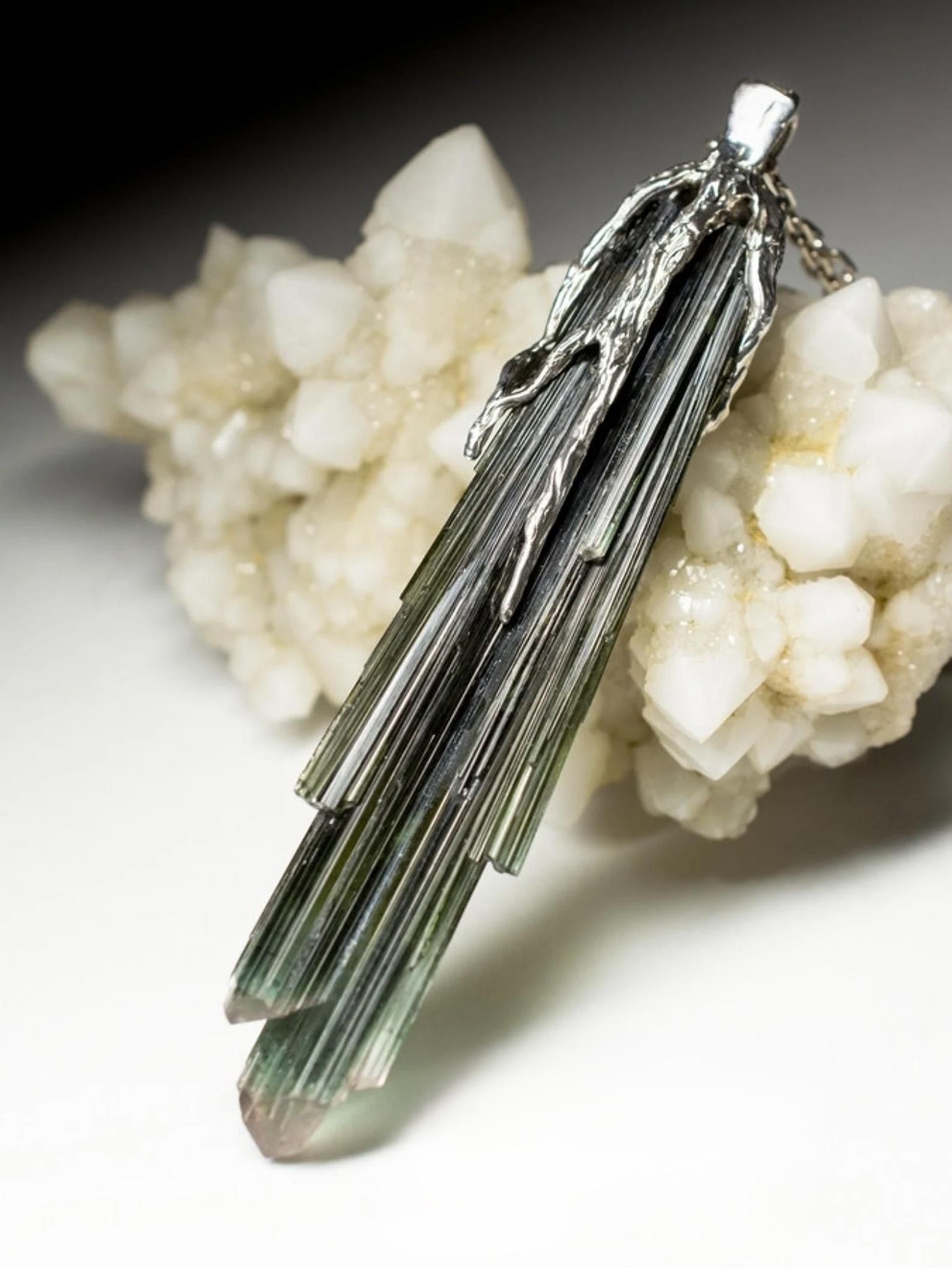 Silver pendant with natural Crystal of Tourmaline
tourmaline spray with an ideal surface structure without damage
tourmaline origin - Pakistan
stone measurements - 0.39 х 0.51 х 2.4 in / 10 х 13 х 61 mm
stone weight - 39.80 carats
pendant weight -